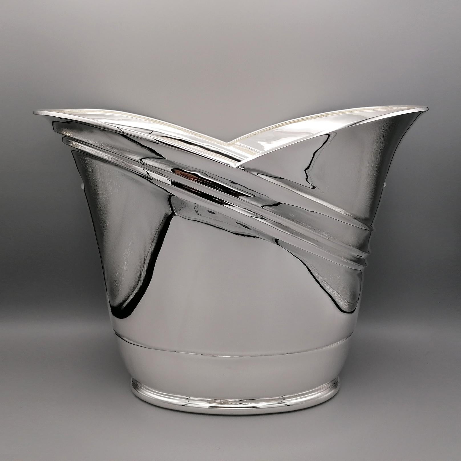 Large oval champagne bucket for 2 bottles in solid sterling silver. 
Made in Italy entirely by hand from the silver sheet and modeled. 
On the body of the bucket, three 