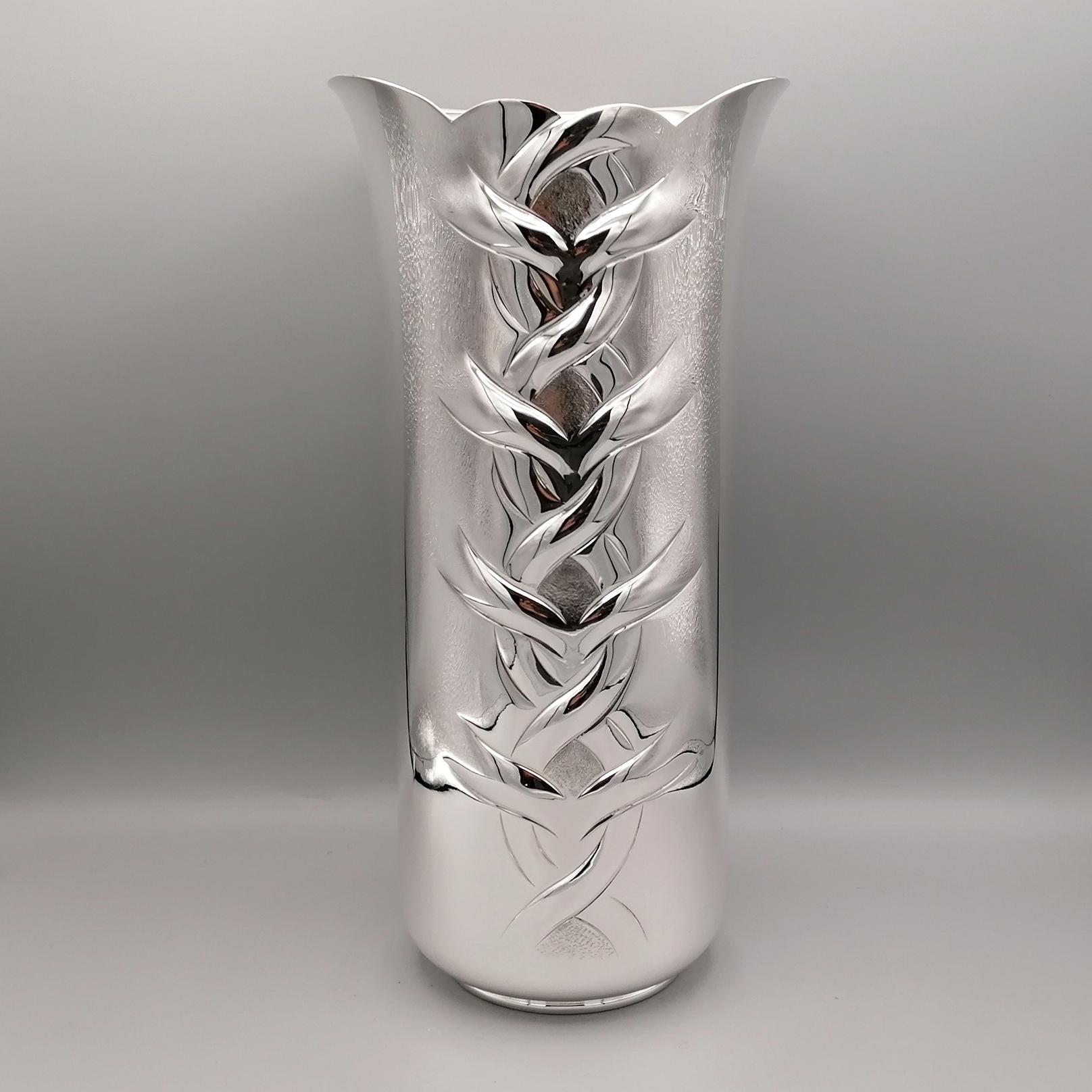 Fully handmade sterling silver vase.
The structure of the body is cylindrical and widens slightly in the upper part, called the mouth of the vase.
The vase is smooth and shiny and is characterized by a central overhang and chisel that defines it