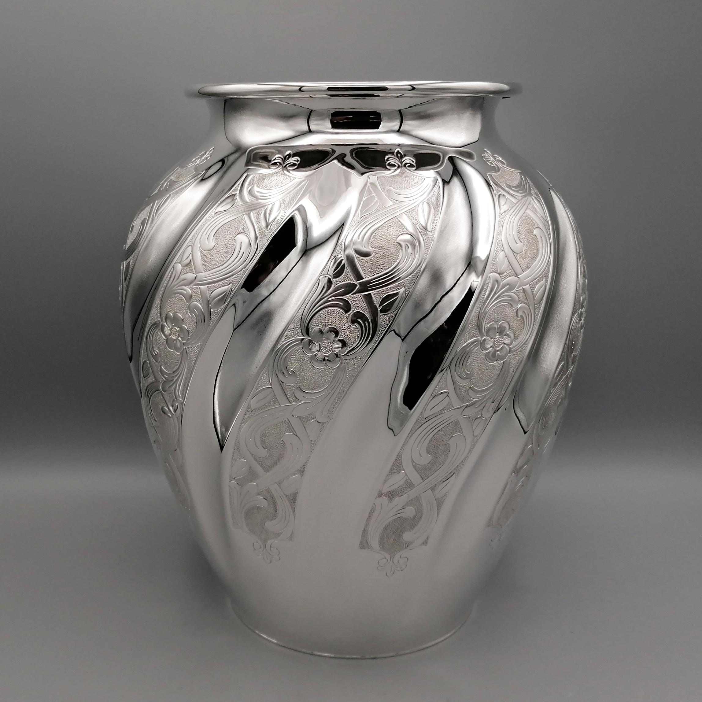 925 Sterling silver vase.
The round pot-bellied vase was made entirely by hand and subsequently embossed with a torchon motif.
The concave grooves have been left polished while the convex ones have been hand engraved with flowers and scrolls. To