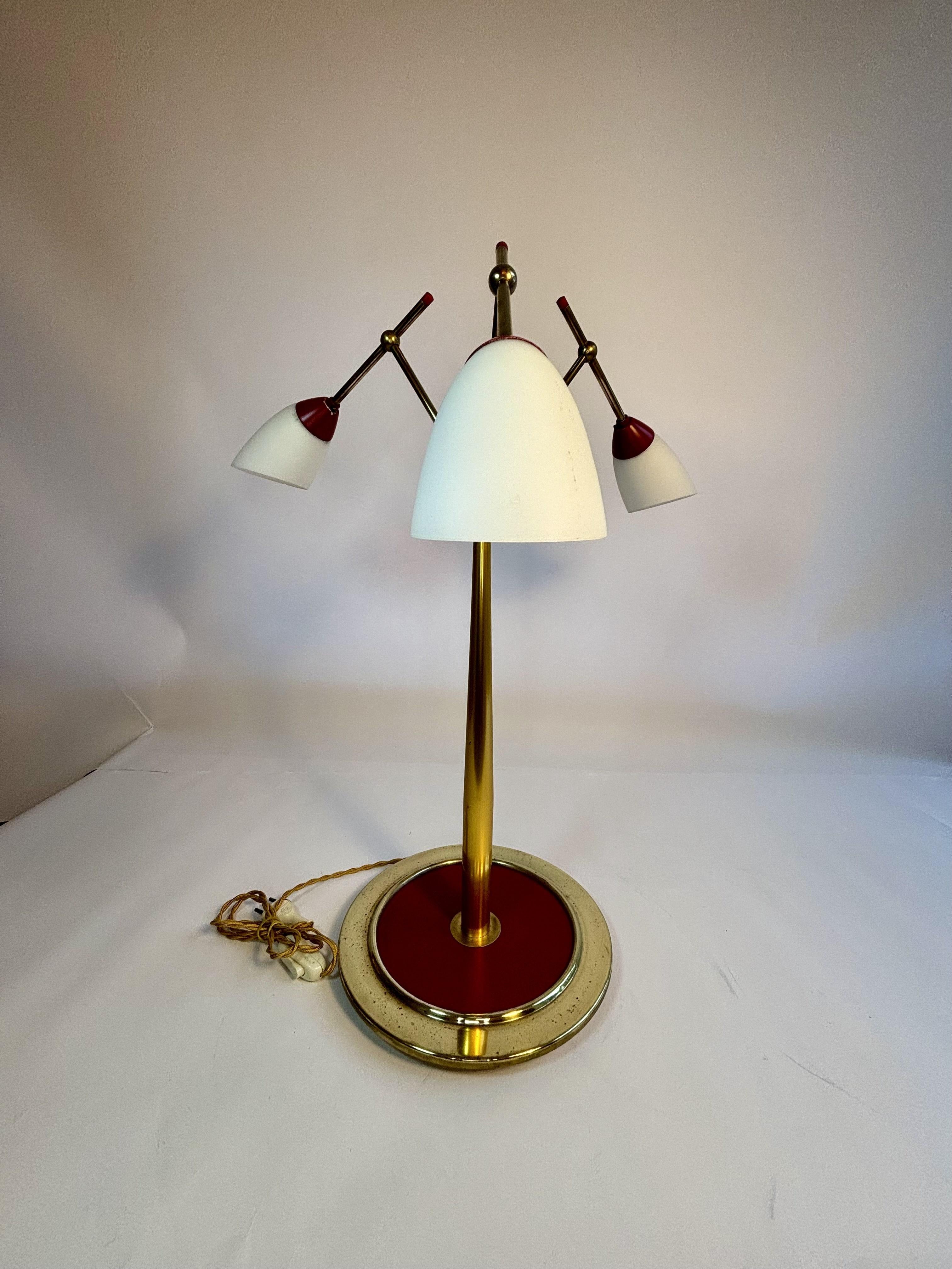 Rare lampe de table Stilnovo du milieu du 20e siècle
Cette exceptionnelle lampe à trois bras de Stilnovo témoigne de l'élégance raffinée du design italien du milieu du siècle dernier. Fabriqué en laiton avec une riche laque rouge, il incarne le