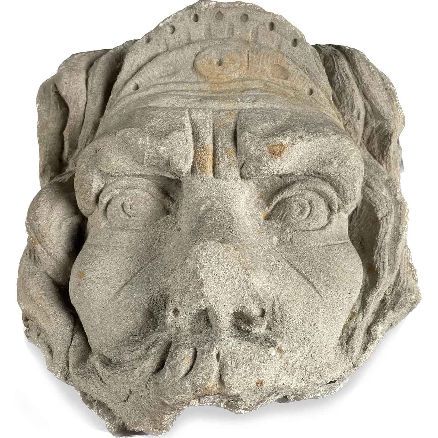 This antique stone mask was probably used in a fountain. It is a very decorative Italian antique object. The mask fits as decorative object on a bureau or placed somewhere else in a living space. This mask depicts a lion head or a moustached male