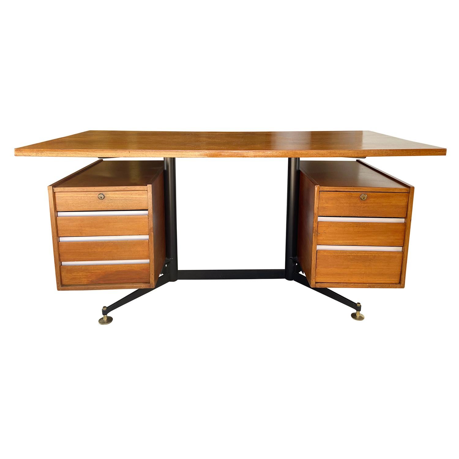 A dark-brown, vintage Mid-Century Modern Italian writing table made of hand carved Teakwood, designed by Gio Ponti, Antonio Fornaroli & Alberto Rosselli and produced by Studio PFR in good condition. The freestanding desk has a floating wooden top,