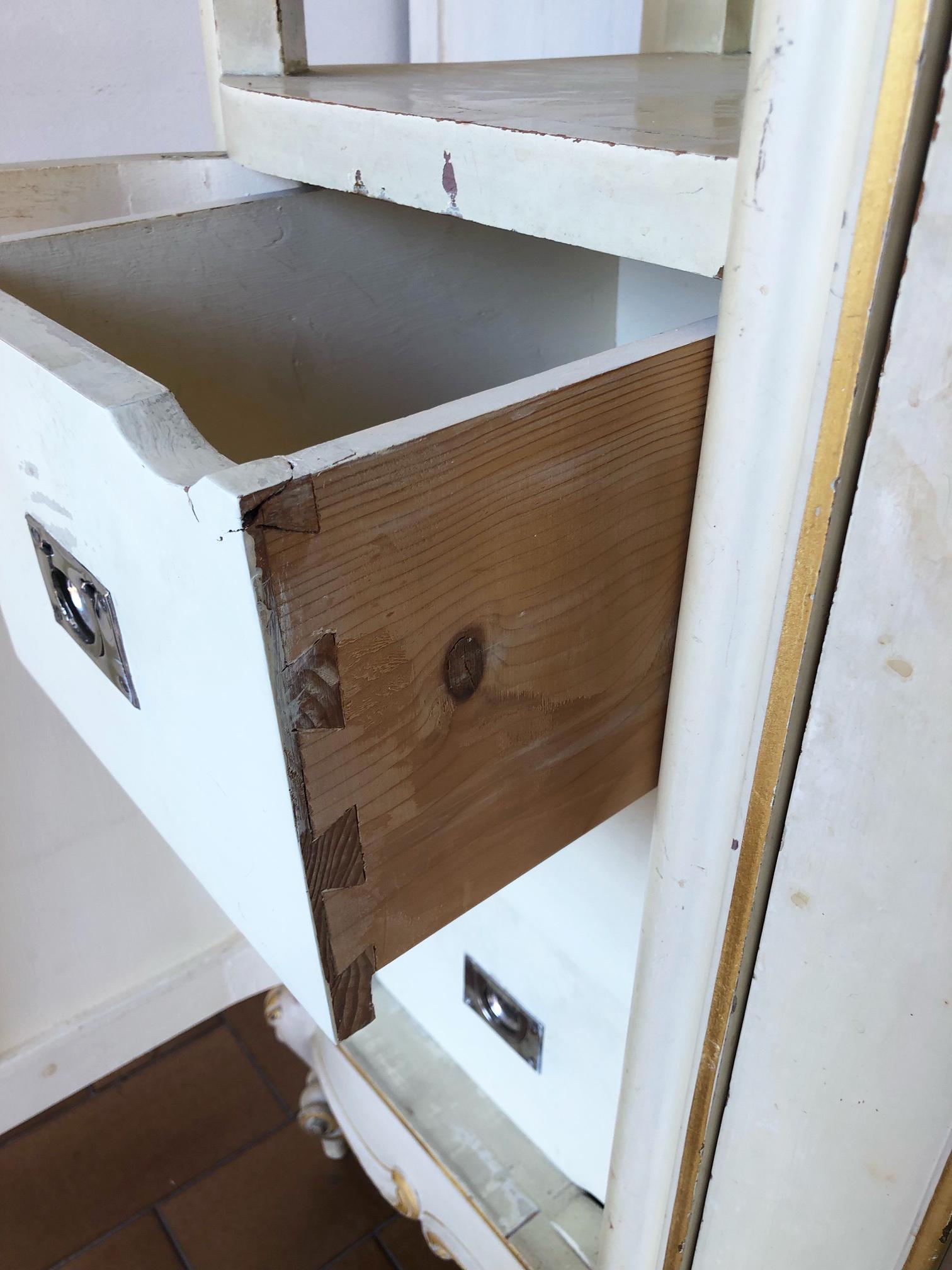 20th Century Italian three door wardrobe original cream and gold.
The wardrobe is made up of three blocks joined together, the lateral ones with three drawers at the bottom and a door at the top and the central one with a mirrored door and clothes