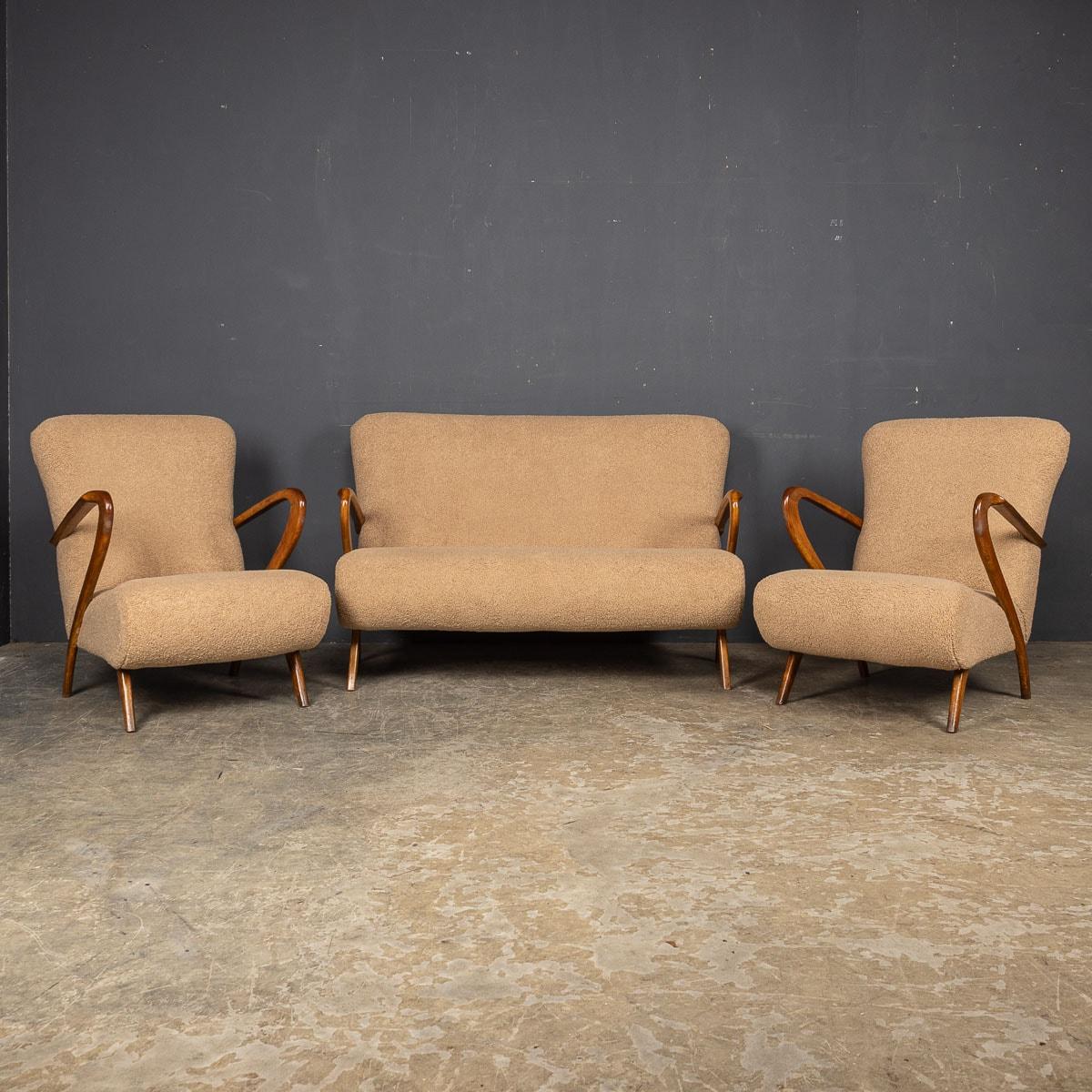 A beautiful set of mid 20th Century Italian armchairs and sofa by Paulo Buffa. These pieces showcase impeccable quality, boasting a sumptuous finish in soft Italian boucle fabric. Their stately proportions and exceptional comfort make them stand