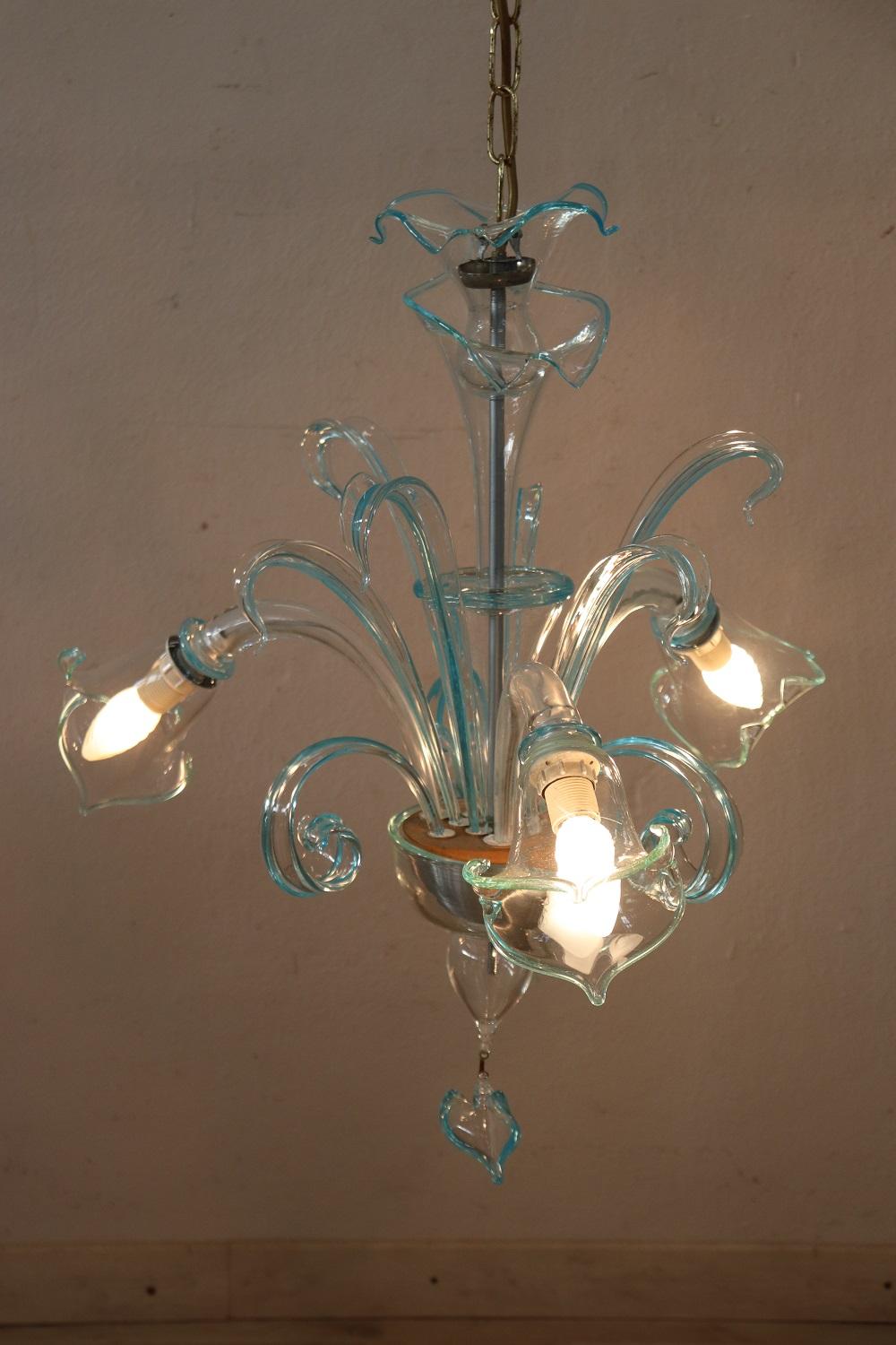 Beautiful and refined artistic glass chandelier of Murano 20th century, 1950s total three light. The chandelier is made with the classic artistic work of Murano glass in delicate and rare transparent and light blur glass. Fully functional. The total