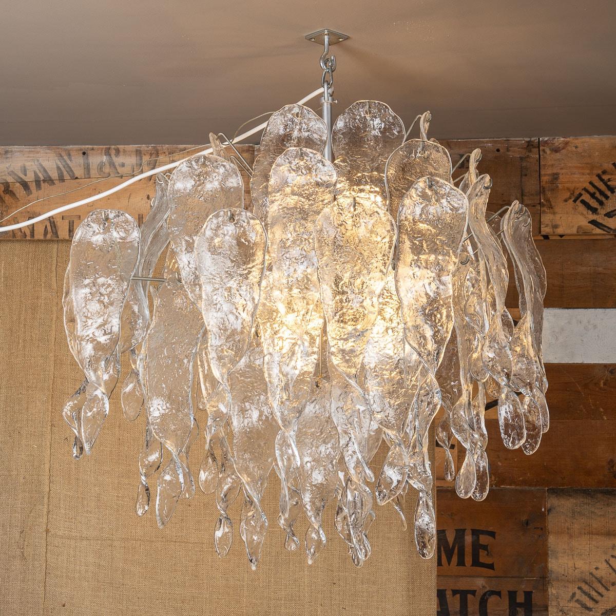Crafted in Murano, Italy by Mazzega during the late 20th century, this drop chandelier embodies a unique and exquisite style. The chandelier's structure is meticulously fashioned from high-quality Murano glass. Its pendant design boasts long,