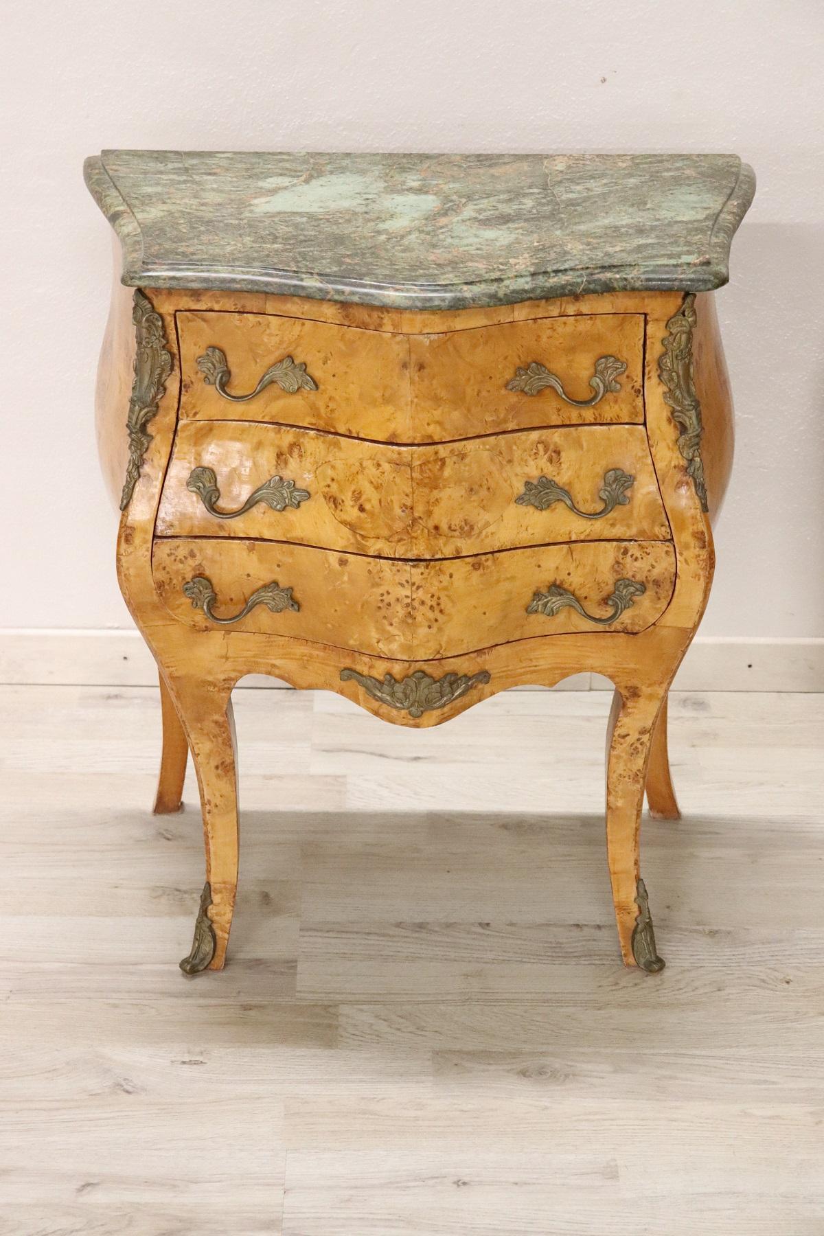 Italian Venetian Louis XV style furniture richly adorned with chiseled bronze. The rare birch wood burl. The top is in precious green marble. Particular rounded shape. On the front three comfortable and spacious drawers. A pair of really elegant ,