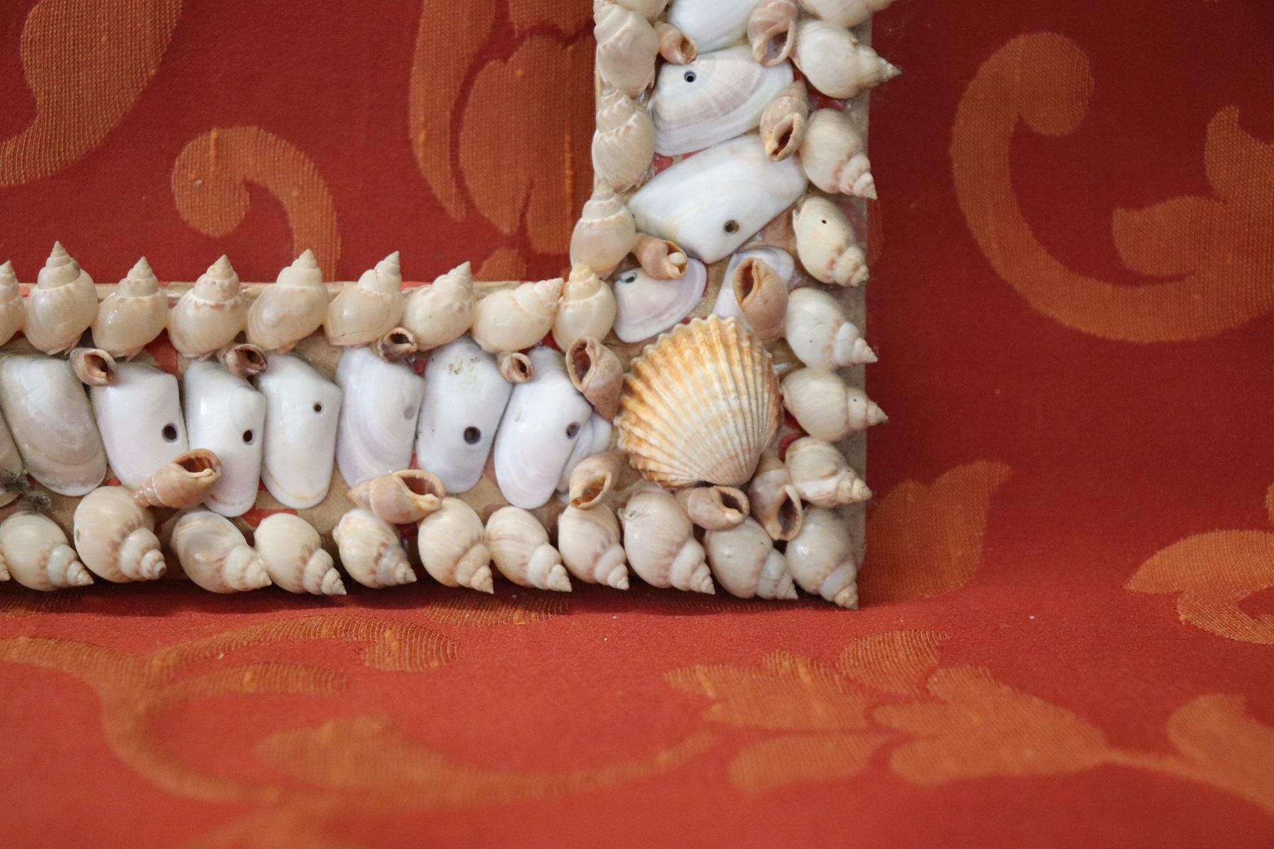 Italian Artistic photo frame made entirely with small shells. Ideal for decorating the walls of a beach house. Glued on cardboard. Sold in the conditions as photos do not have glass and wall hooking. Possible some small missing shell.