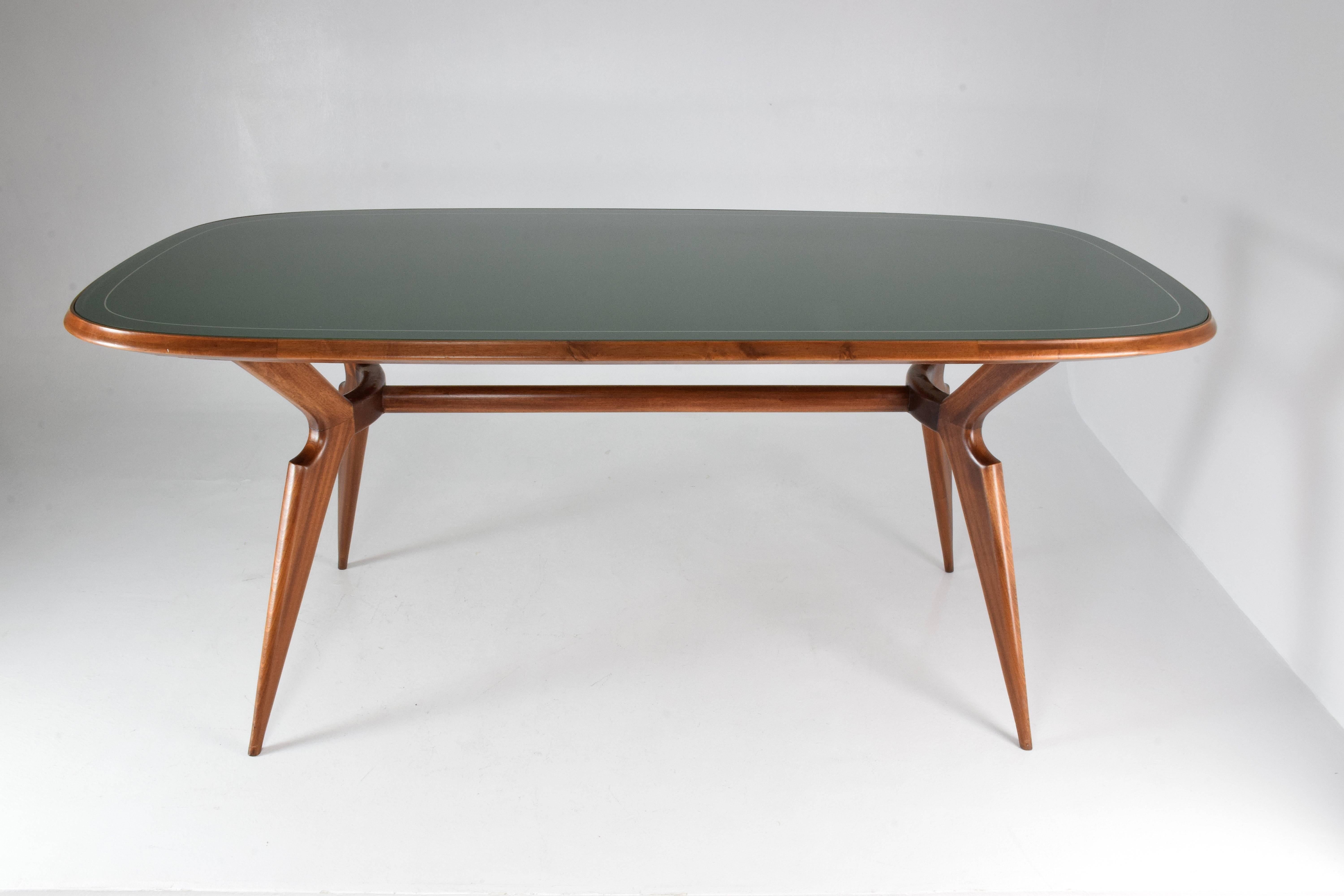 20th-century Italian vintage dining table composed of a beechwood structure designed with splayed and tapered legs typical of the Italian design period, green-colored glass tabletop with a silver lining surrounding the rounded shape.
Italy, circa