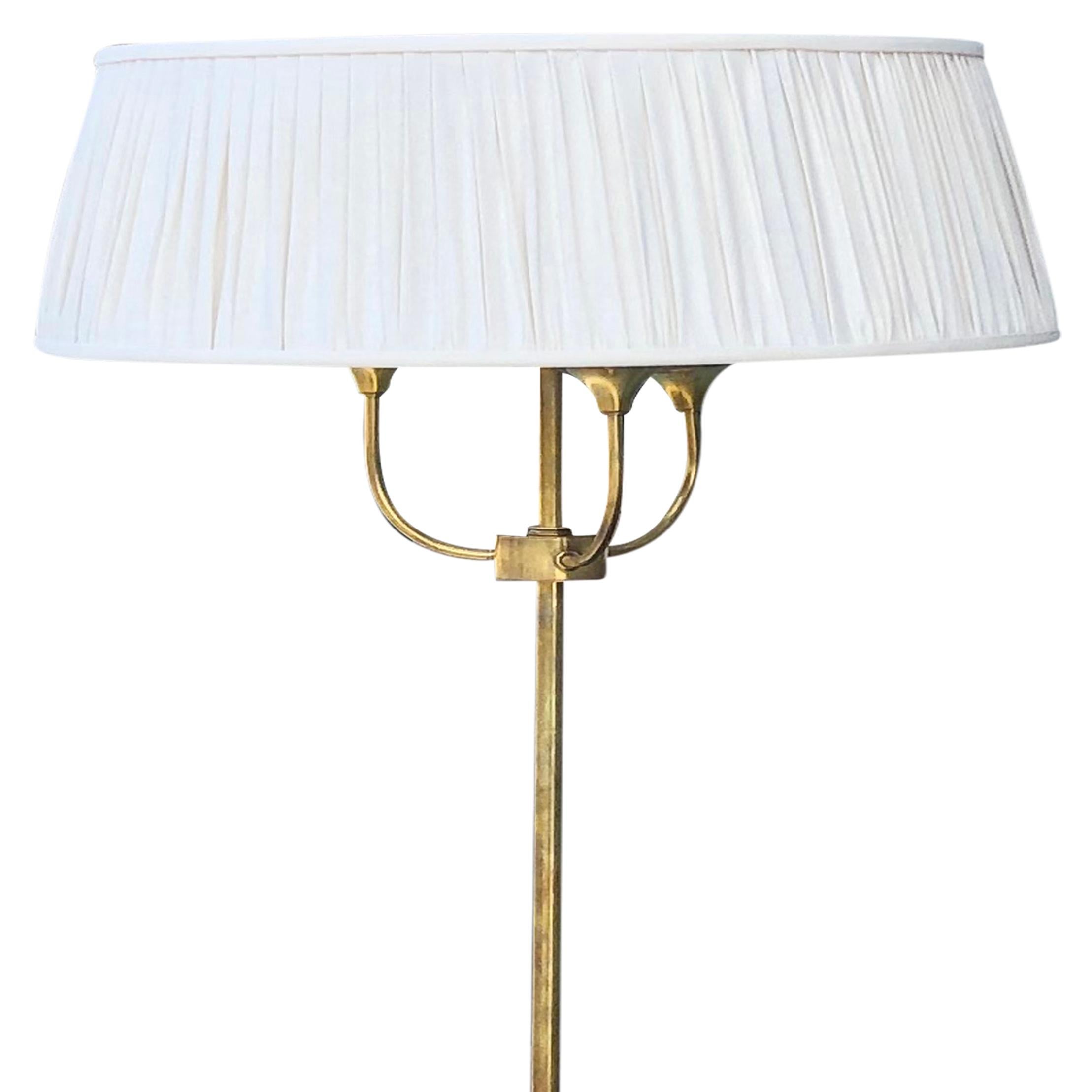 A vintage Mid-Century modern Italian floor lamp with a white-grey shade and a small round table, made of hand crafted brass and rosewood. Featuring a three light socket, in good condition. The wires have been renewed. Wear consistent with age and