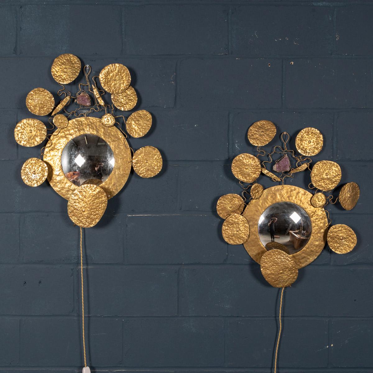 A fantastic pair of wall lights by Missoni, made in Italy around 1980. A round convex mirror surrounded by leaves of naturalistic form made in hammered brass, amethyst blocks to the top and light fittings to the bottom. An extremely eccentric item