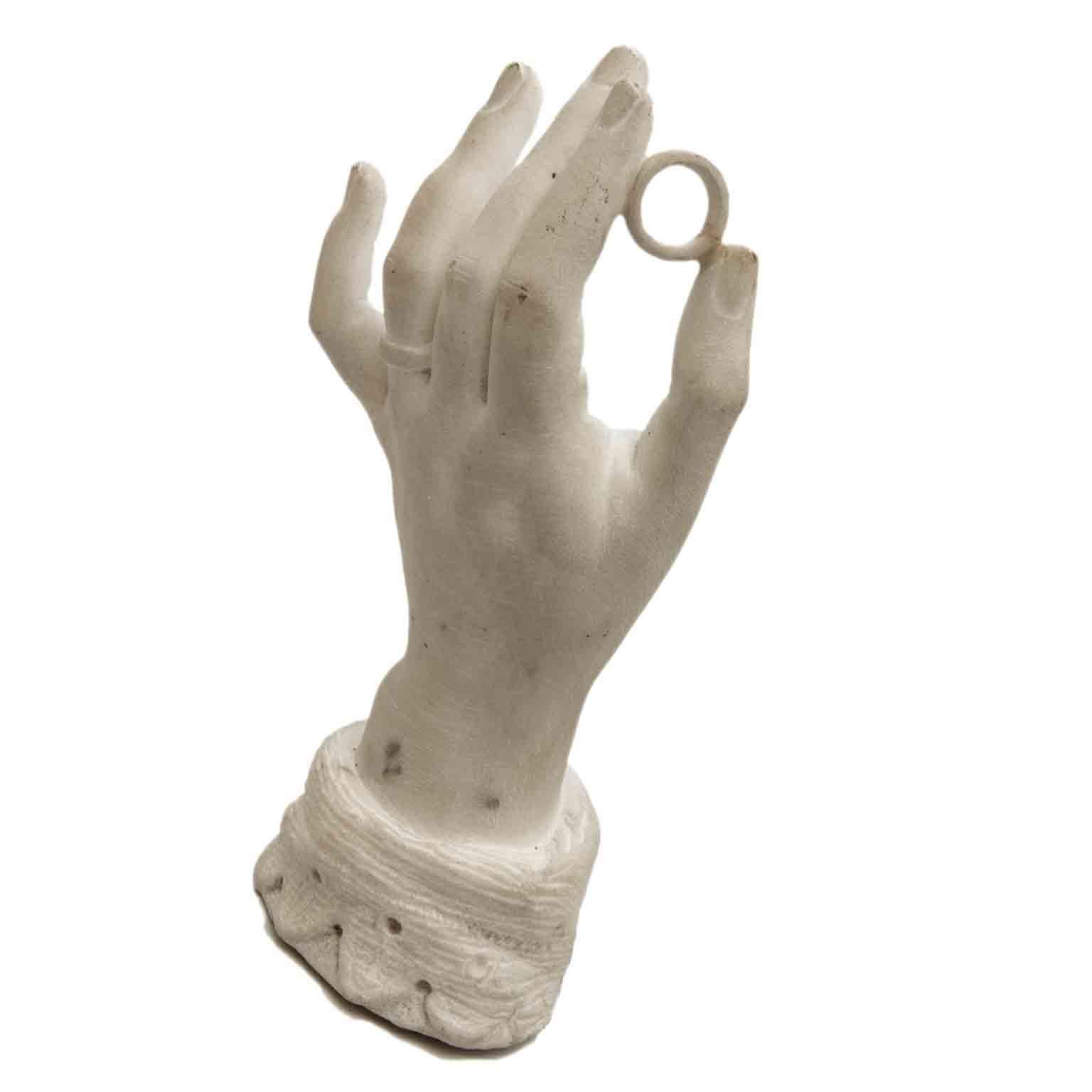A 20th century Italian white marble sculpture of the left hand of a bride, a carved Carrara marble hand sculpture, realized as ring-holder or paperweight, since the carving of the cuff sleeve is missing in the lower part, at the bottom. 

A unique