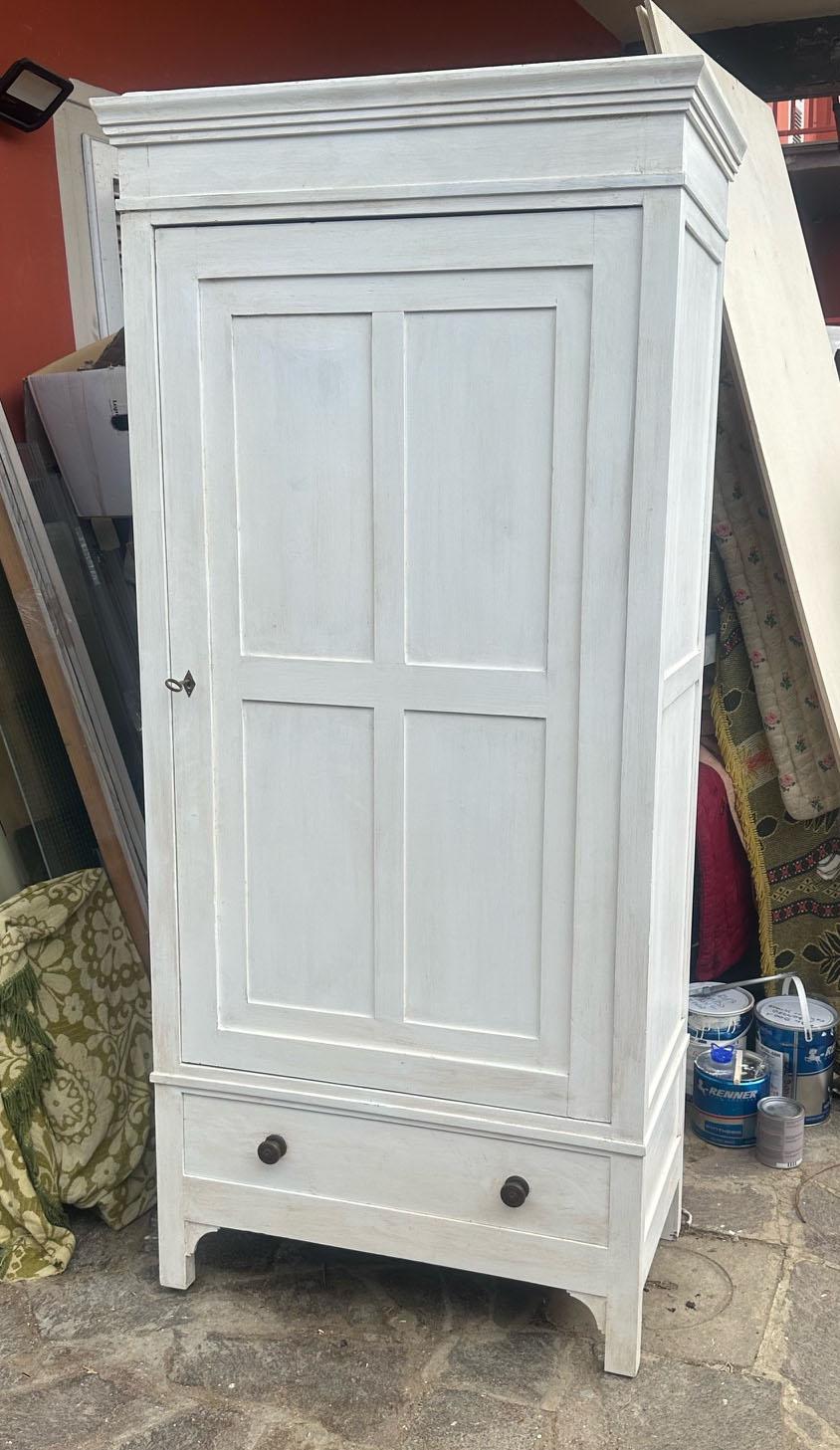 20th Century Italian shabby  white Wardrobe with one door and drawer. 
Inside there is a clothes rail and it is finished with shellac and wax in light walnut colour. 
Remember that the wardrobe cannot be dismantled, so if it has to fit through