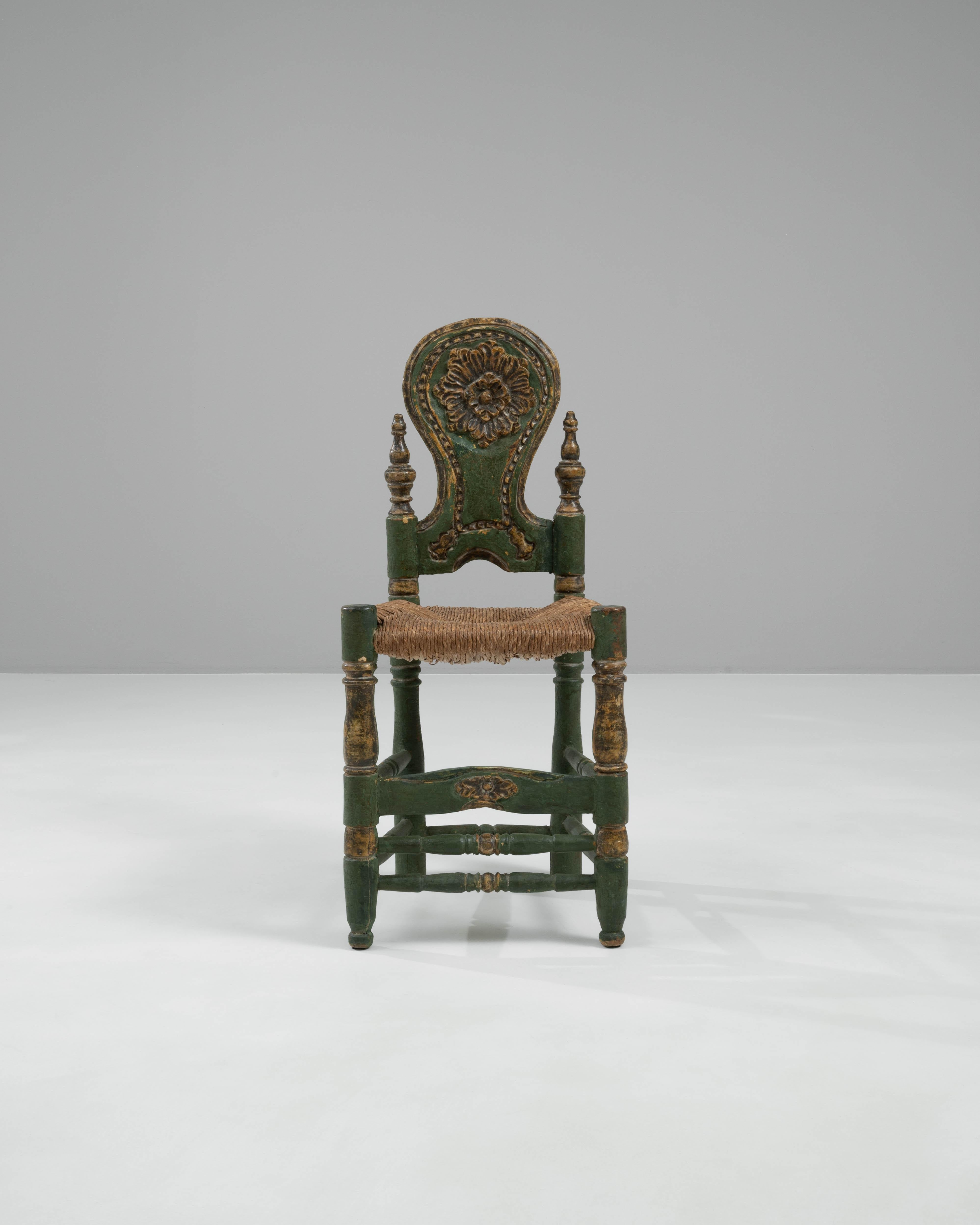 Add a splash of vintage charm to your décor with this 20th Century Italian Wooden Chair. Crafted with attention to detail, this chair features an eye-catching green finish with natural distressing that enhances its antique look. The intricate,