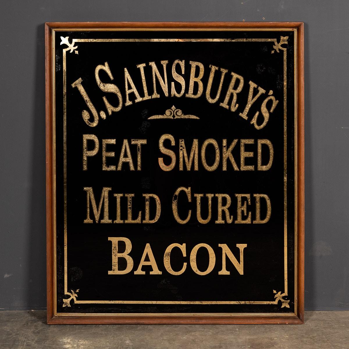 A mid 20th Century English J. Sainsbury's advertising mirror in an original oak frame. Advertising bacon for J Sainsbury, painted in black and gold lettering.

CONDITION
In Good Condition. Wear as expected with age. Please refer to photographs.