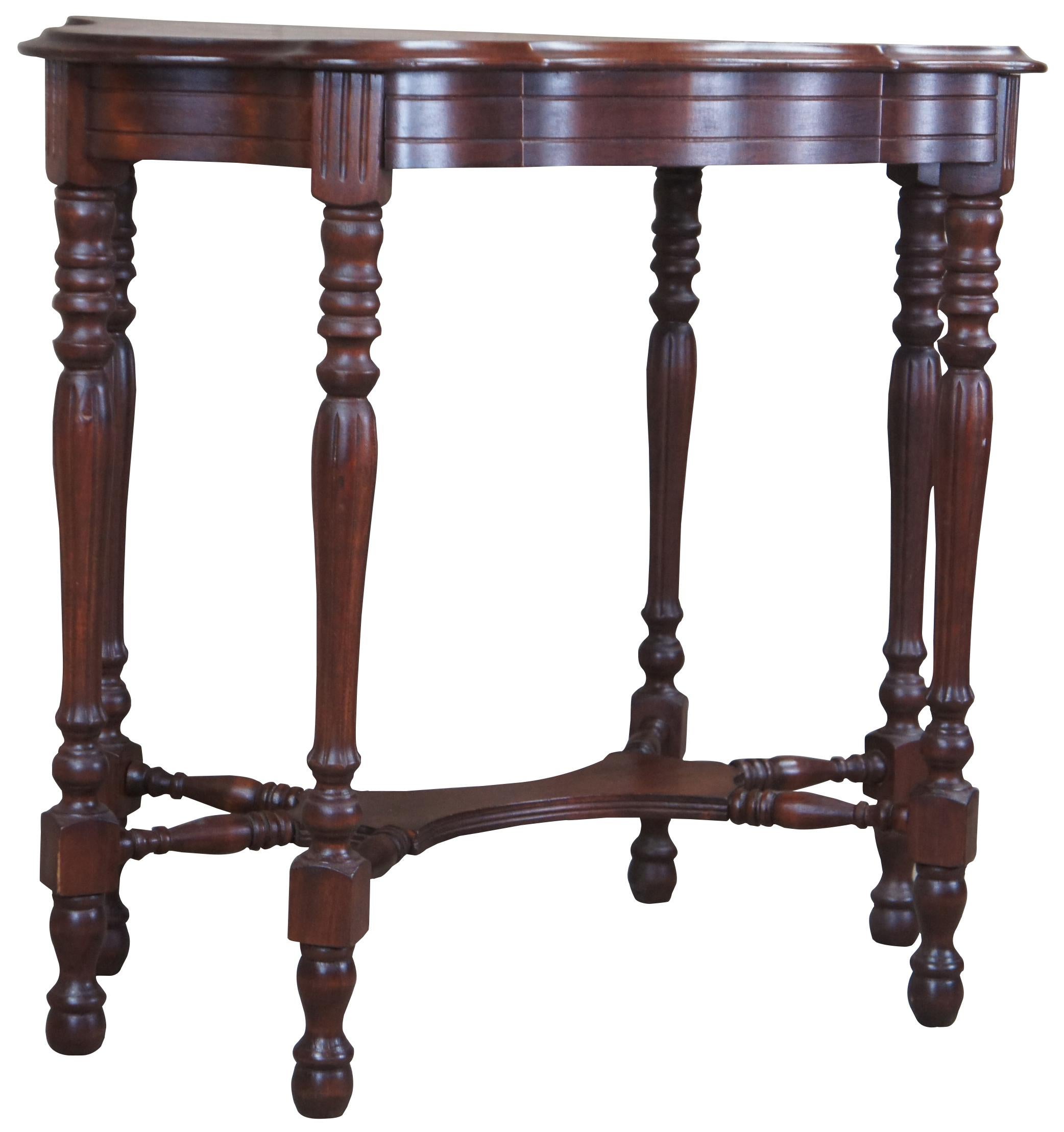 Vintage Jacobean turtle top side table. Made of walnut with scalloped shape with ogee edge. The table is supported by six turned legs tapering fluted legs connected by a turned stretcher and nubby feet.
 
