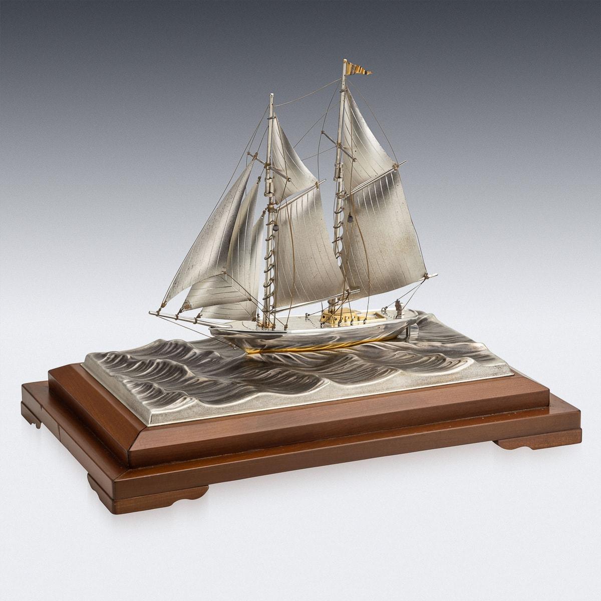 Mid 20th Century Japanese hand crafted silver yacht, presented in its original glass case and wooden plinth.

CONDITION
In Great Condition - No Damage.

SIZE
Height: 32cm
Width: 32cm
Depth: 20cm.