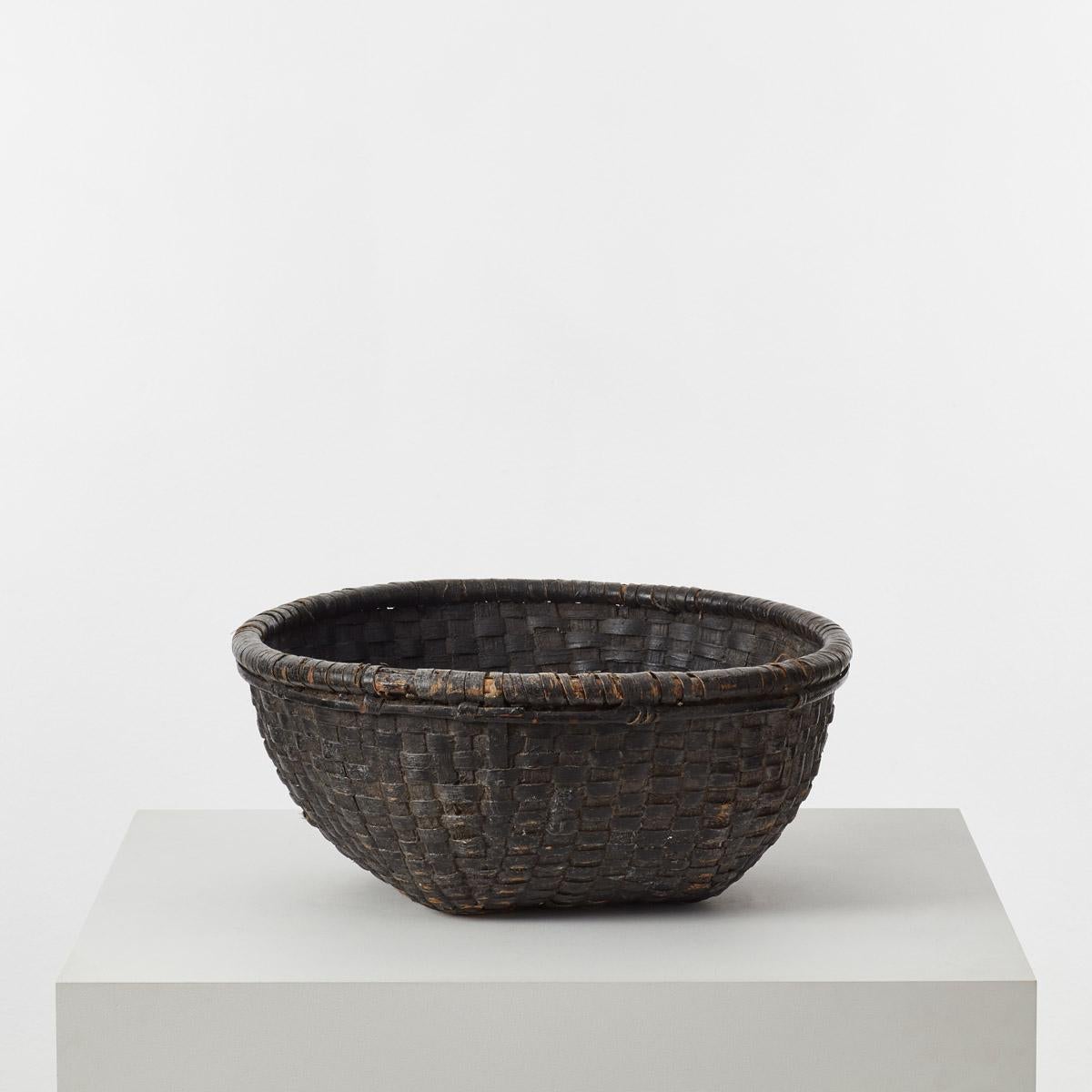A well-constructed folk art antique basket from Japan, makes for an ideal piece of household storage or fruit basket. Possibly woven from willow grain, bark or bamboo, this wabi-sabi vessel is tightly bound to hold small grains like rice, as well as