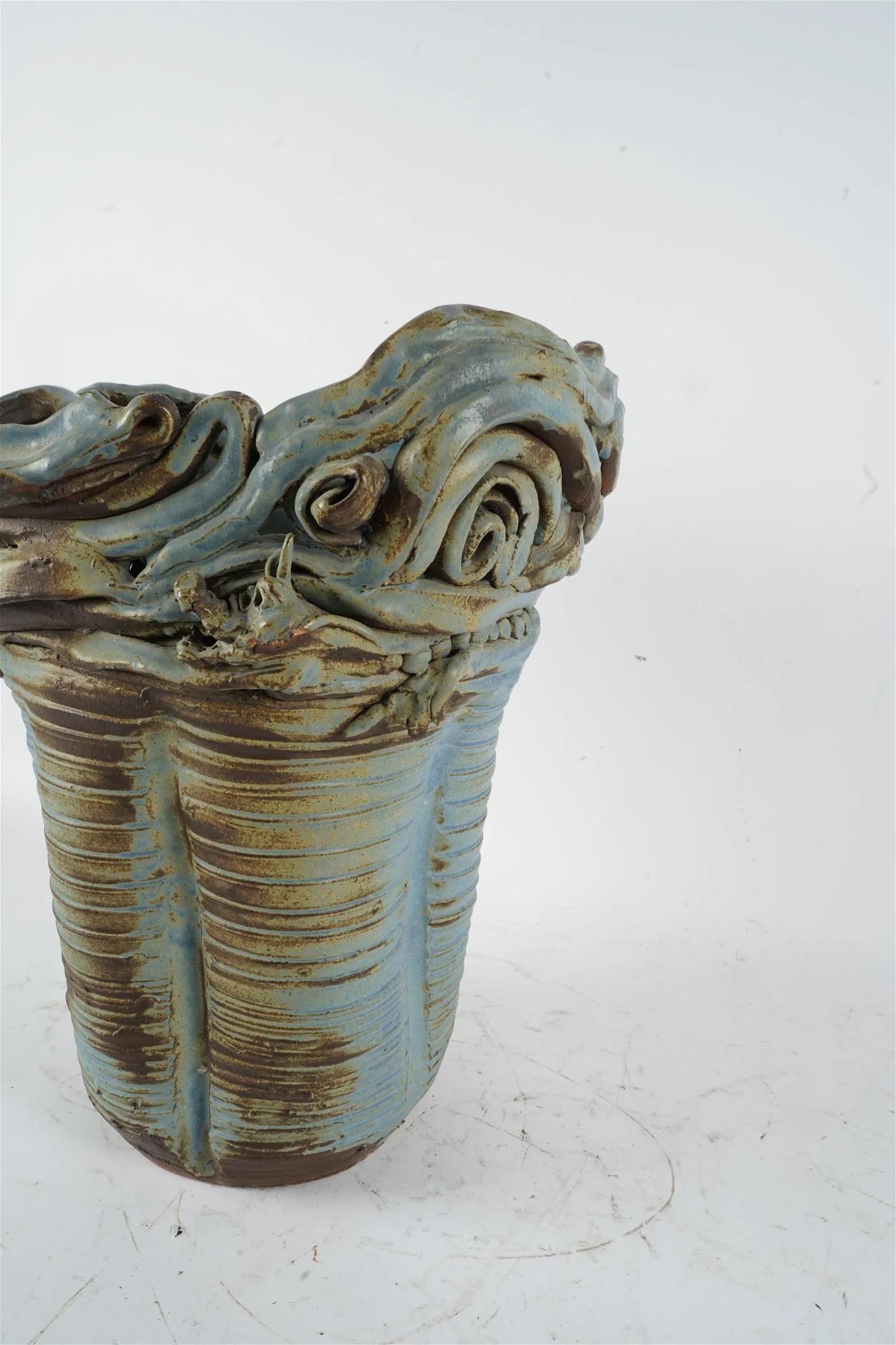 Incredibly special 20th Century one-of-a-kind large ceramic vase finished in a blue-glaze with an abstract dragon wrapping around the top. 