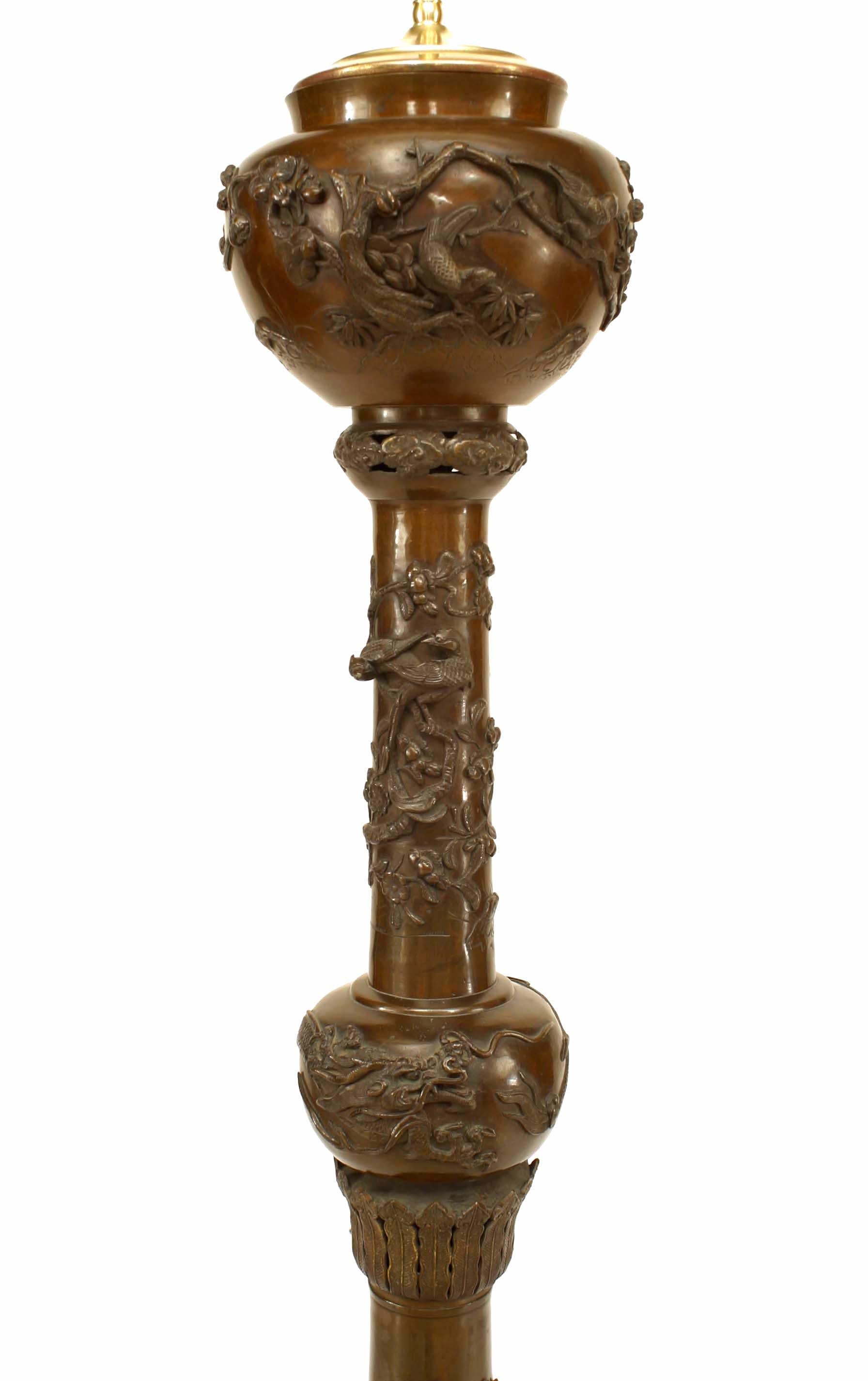 Asian Japanese style (19th/20th century) bronze column form floor lamp with foliate and bird relief detail culminating in urn top.
 