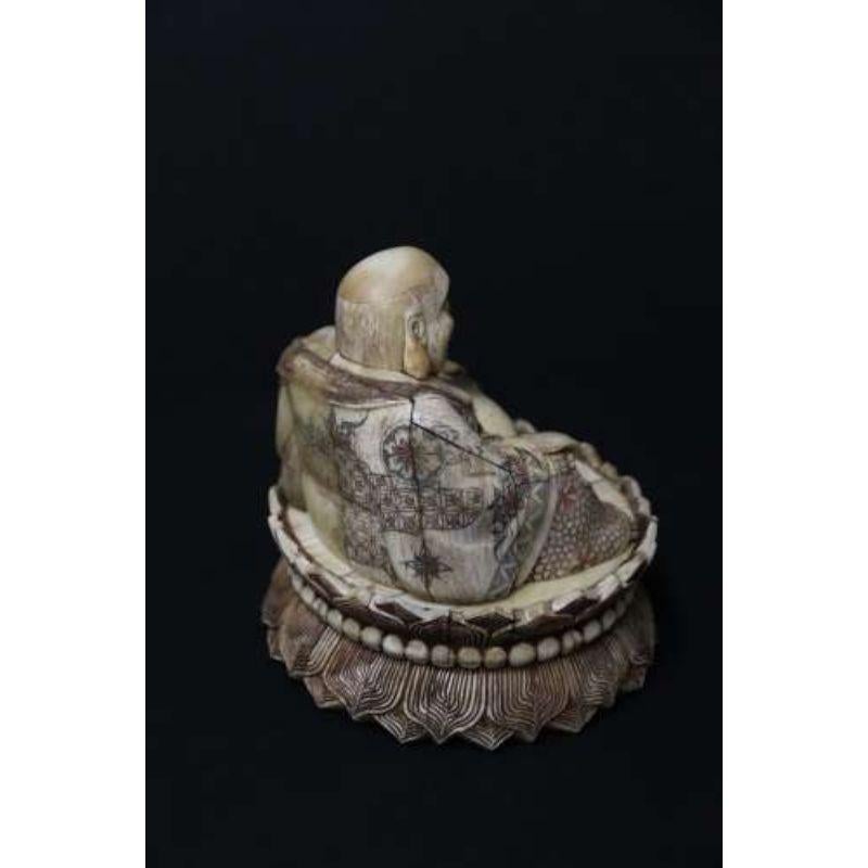 20th Century Japanese carved bone okimono carved figure of the seated buddha.

This interesting early 20th century Japanese carved bone Okimono figure depicts the seated Buddha. He is sitting upon a raised plinth which has a circle of carved beads