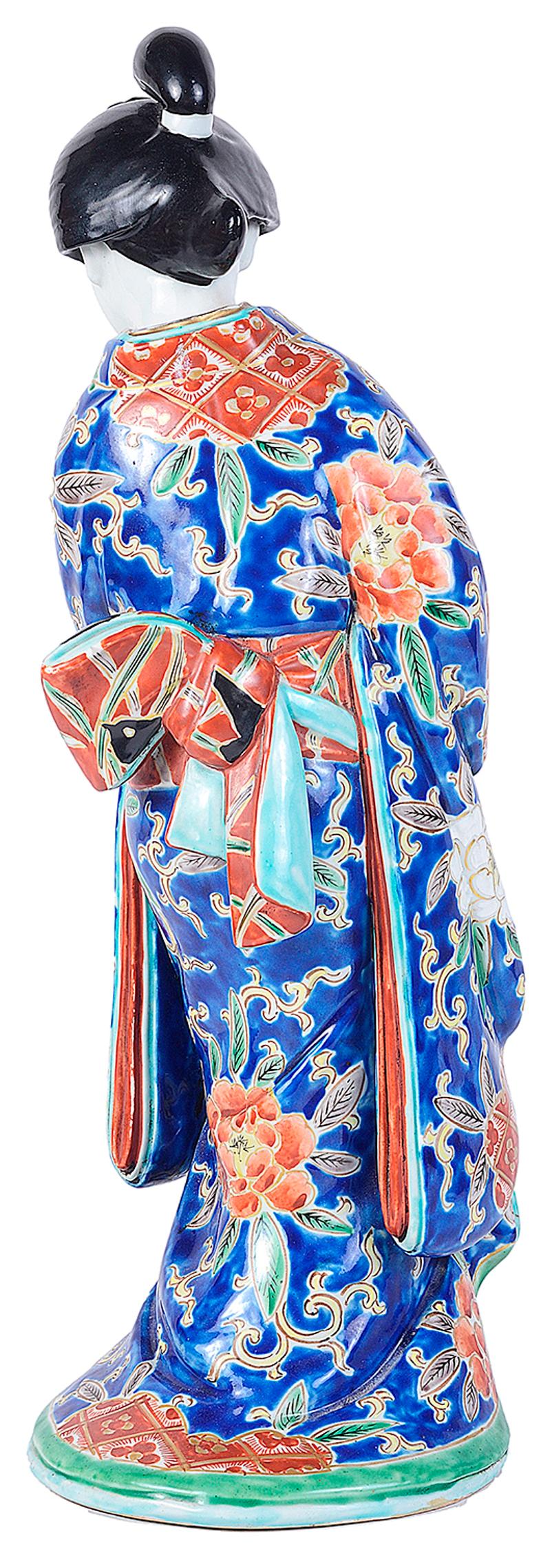A good quality early 20th century Imari porcelain figure of a Geisha, having a wonderfully exotic colored kimono.
   