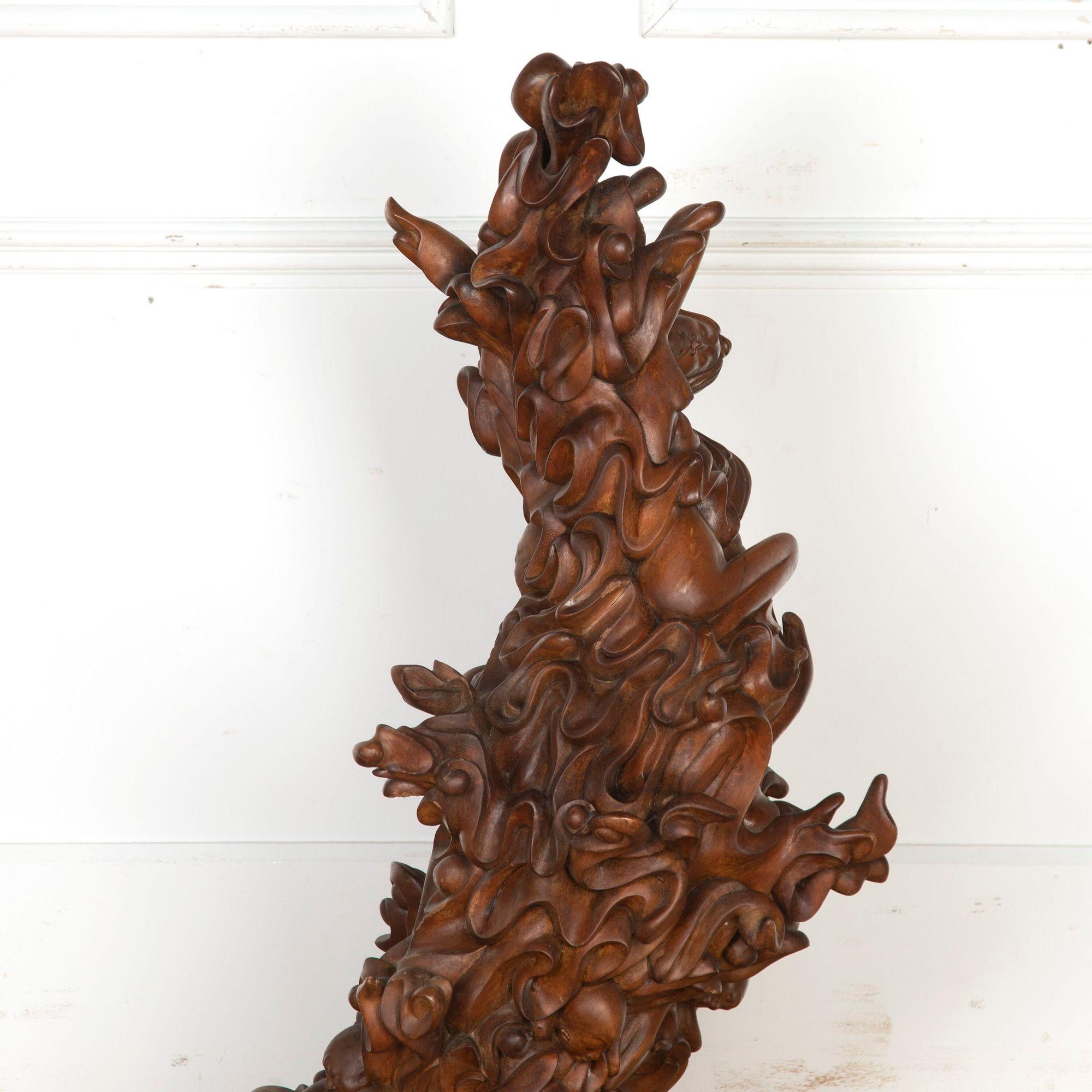 Fantastic 20th Century Javanese biomorphic sculpture. 
This beautiful, hand-carved sculpture depicts waves and floating figures with wonderful movement throughout. 
It is composed of rich and dark wood that is smooth to the touch and beautifully