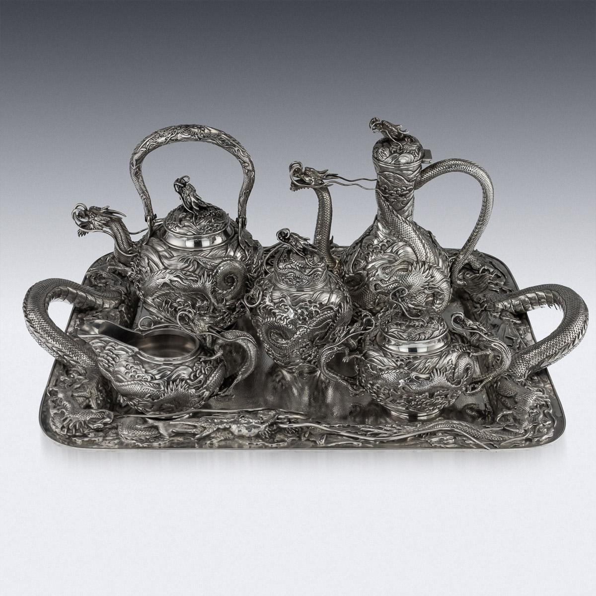 Description

Antique early-20th century Japanese Meiji period, solid silver large five-piece tea and coffee service on tray, exceptional and magnificent quality, double walled, chased, embossed and applied with a water dragon in very high relief,
