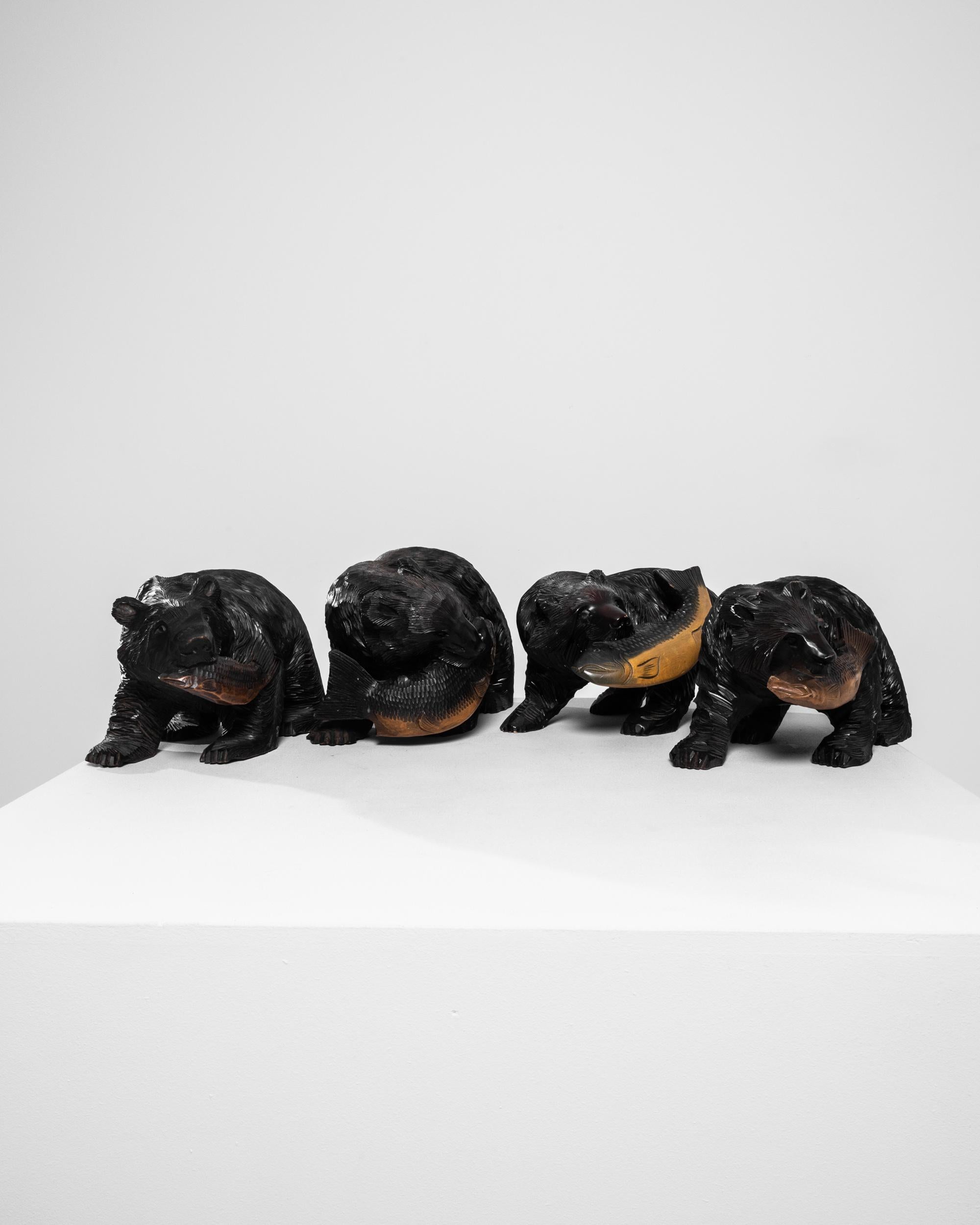 This striking 20th-century Japanese wooden bear sculpture is a true masterpiece of traditional craftsmanship. Expertly hand-carved from dark, rich wood, the sculpture depicts a powerful bear triumphantly holding a golden fish in its mouth. The