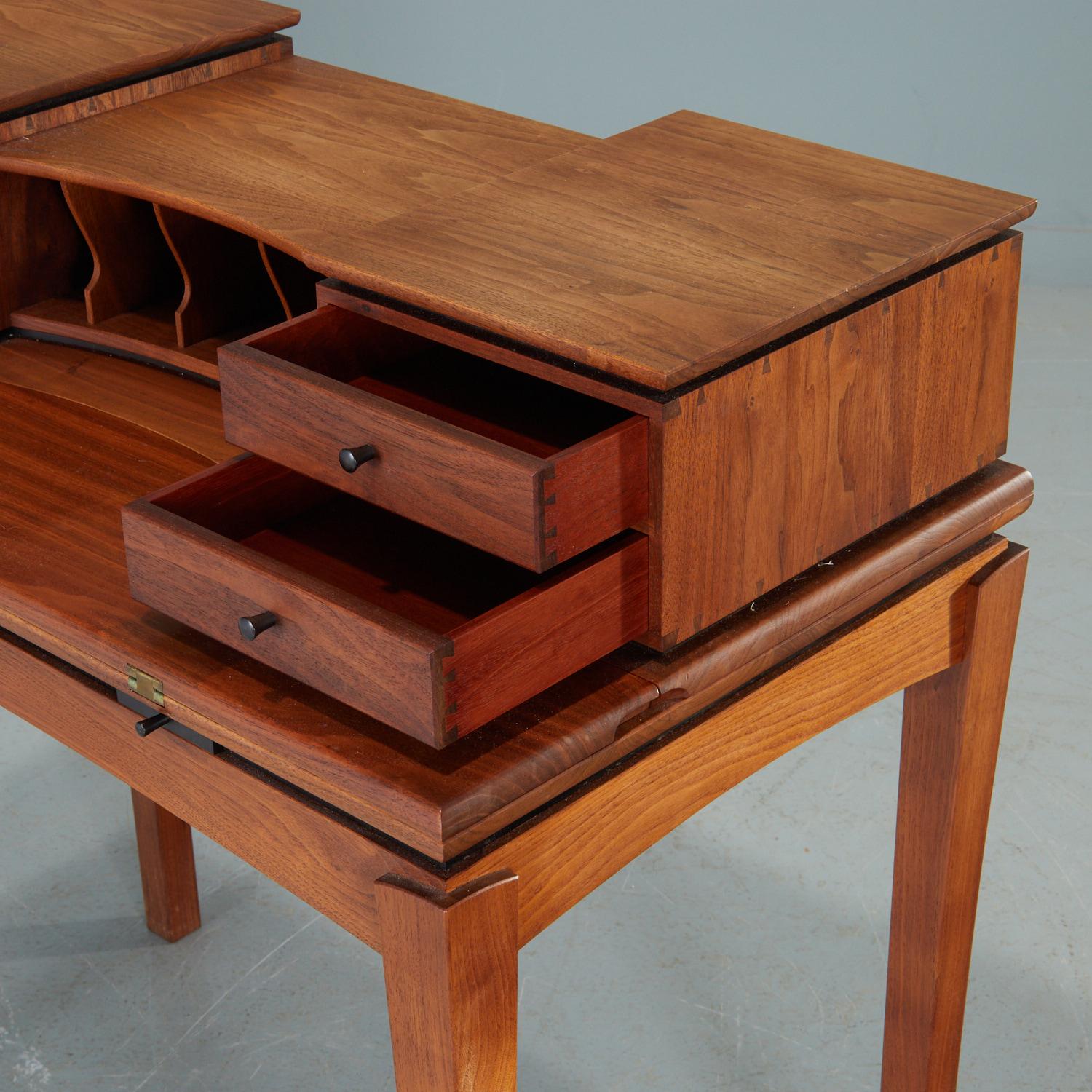 c. 1988, John Sherrif mixed wood writing desk and chair, in walnut, ebony, and mahogany. The desk with gallery of drawers and cubbies, initialed 