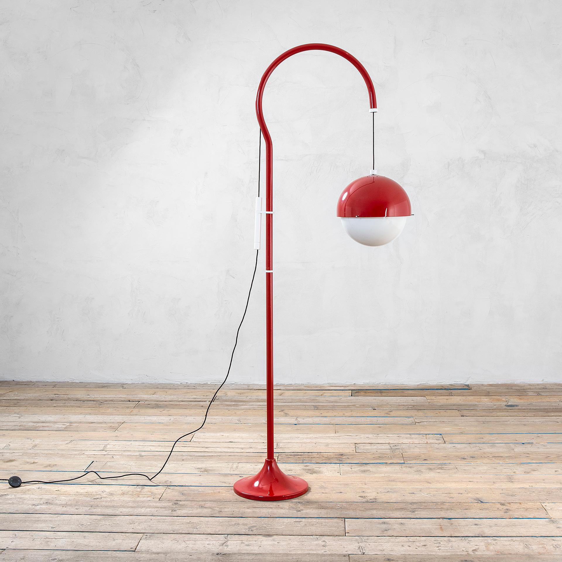Floor lamp designed by Luigi Bandini Buti in '70s for the Manufacturer Kartell. The floor lamp model 4055 has a structure in red lacquered metal and the round diffuser is in perspex. A smart system along the structure allows to move the diffuser up