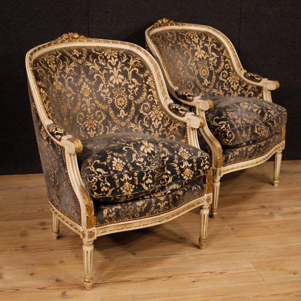 Pair of Italian armchairs from 20th century. Furniture in carved, lacquered and gilded wood of excellent quality. Armchairs finished for the center covered in damask velvet in good condition, with some small signs of wear. Easily insertable