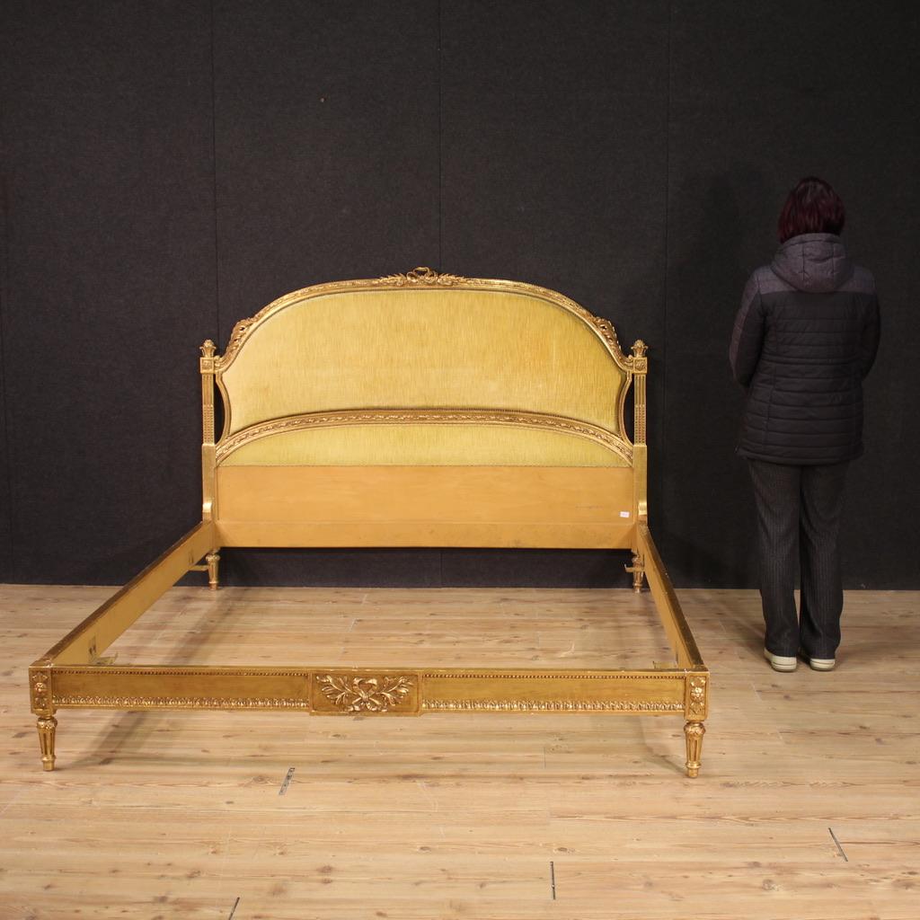 Italian double bed from the mid-20th century. Decorative bed frame in Louis XVI style, finely carved and gilded. Headboard adorned with padded velvet upholstery (in good condition, see photos). Excellent quality furniture, made up of four separable