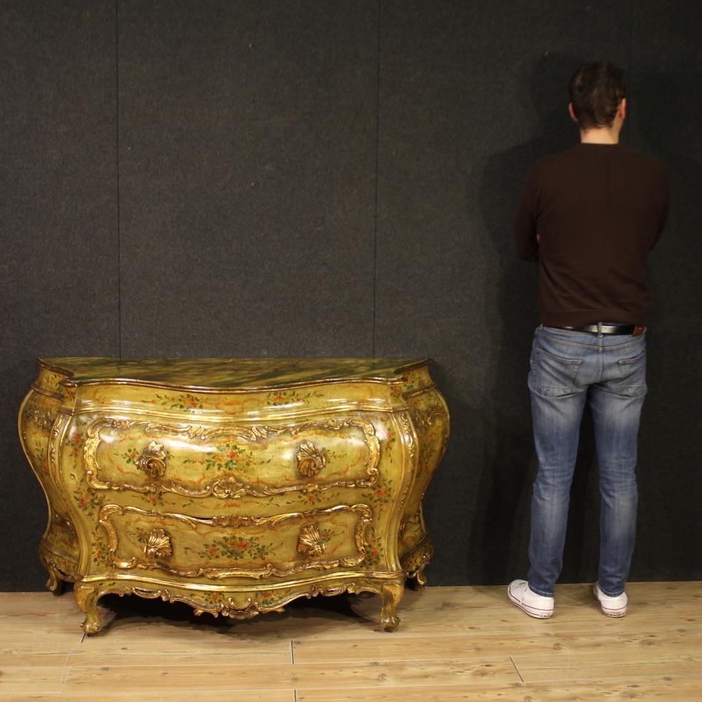 Scenic Italian chest of drawers from the mid-20th century. Richly carved, lacquered and gilded wooden furniture with floral motifs in Venetian style, very pleasant. Commode with two drawers of excellent capacity and service. Top painted in faux
