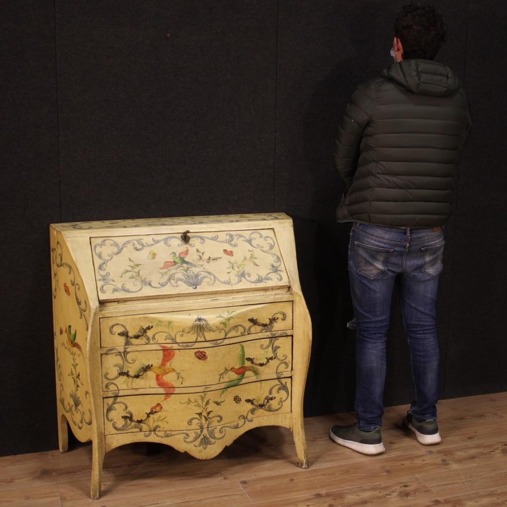 Italian bureau from the 20th century. Moved and rounded furniture in lacquered and hand-painted wood with floral and animal decorations. Bureau of fabulous decor, ideal to be placed in a living room or studio, equipped with three external drawers of