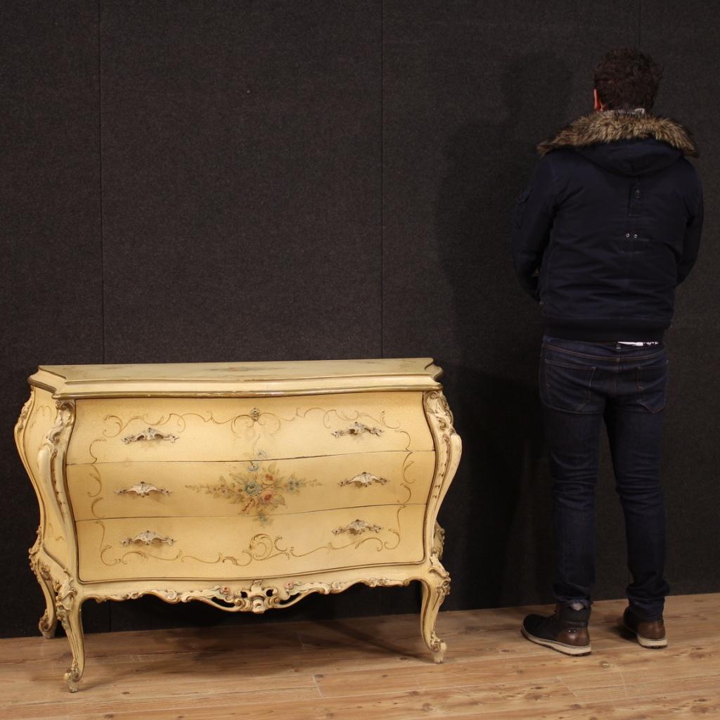 Venetian commode from the 20th century. Furniture in lacquered, gilded (bronze color) and hand painted wood with floral decorations of great pleasure. Curved and rounded commode equipped with three front drawers of good capacity. Top drawer complete