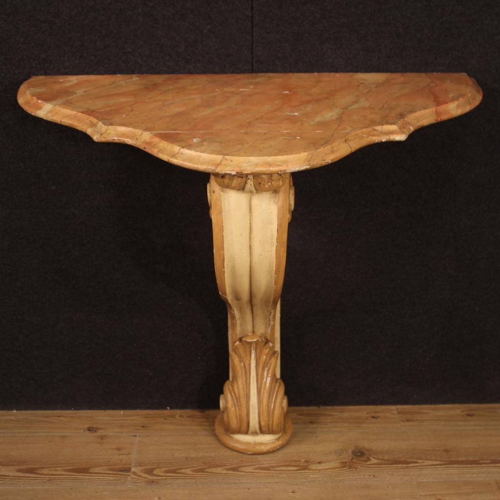 Italian console from the mid-twentieth century. Furniture of beautiful line and pleasant decor in carved, lacquered and painted wood. Wall console, supported by a solid central leg finely sculpted and lacquered, to be fixed to the wall for perfect