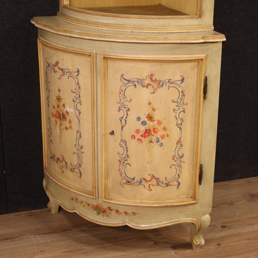 20th century Italian corner cupboard. Furniture in carved, lacquered and hand painted wood with very pleasant floral decorations. Double body corner cabinet with two doors in the lower part (with working key) and internal shelf. Upper open body with