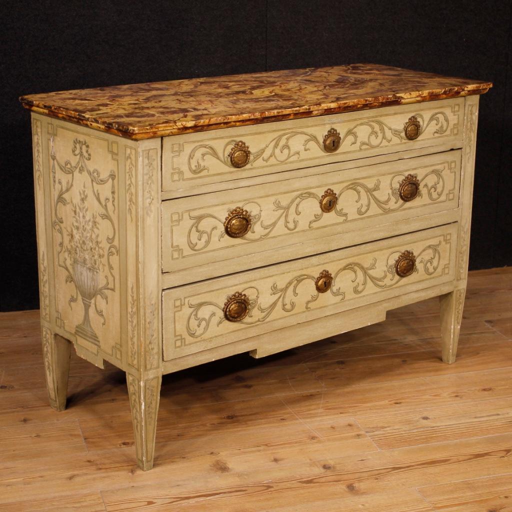 Italian commode in Louis XVI style from 20th century. Beautiful line furniture of pleasant decor in lacquered and hand painted wood in neoclassical style. High quality faux marble lacquered wooden top. Chest of drawers with three front drawers