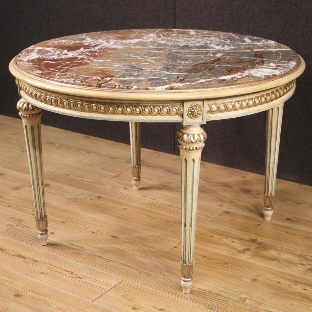 Italian table from the second half of the 20th century. Furniture in carved, lacquered and silvered wood in Louis XVI style of fabulous furnishings. Top in original recessed marble of fabulous quality in perfect condition. Solid table supported by