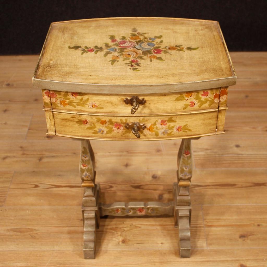 20th century Italian side table. Lacquered and hand painted wooden furniture with very pleasant floral decorations. Side table with two drawers (complete with keys) of good capacity and wooden top, also lacquered and painted. Table finished for the