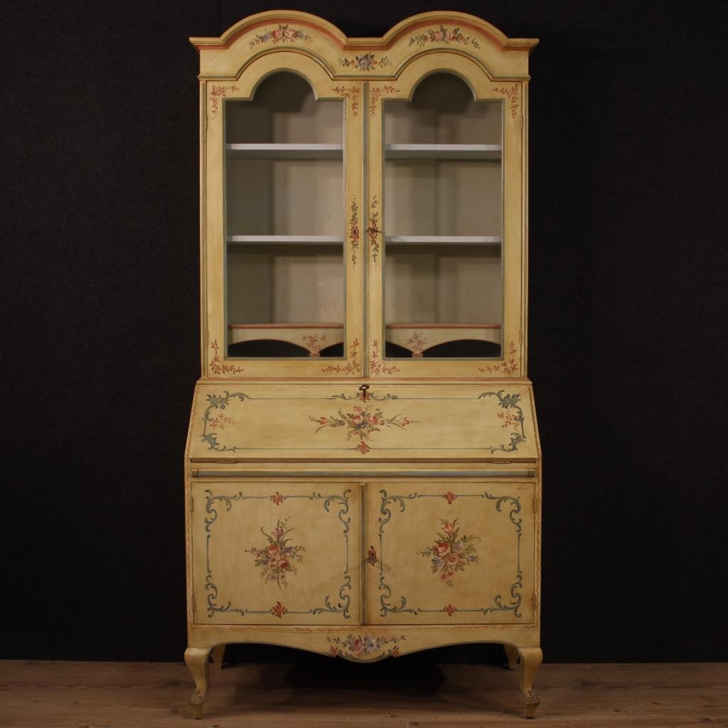 Italian double body trumeau from the 20th century. Furniture in lacquered and hand-painted wood with very pleasant floral decorations. Lower body with two doors with internal shelf plus base and fall-front. Interior of the bureau equipped with desk