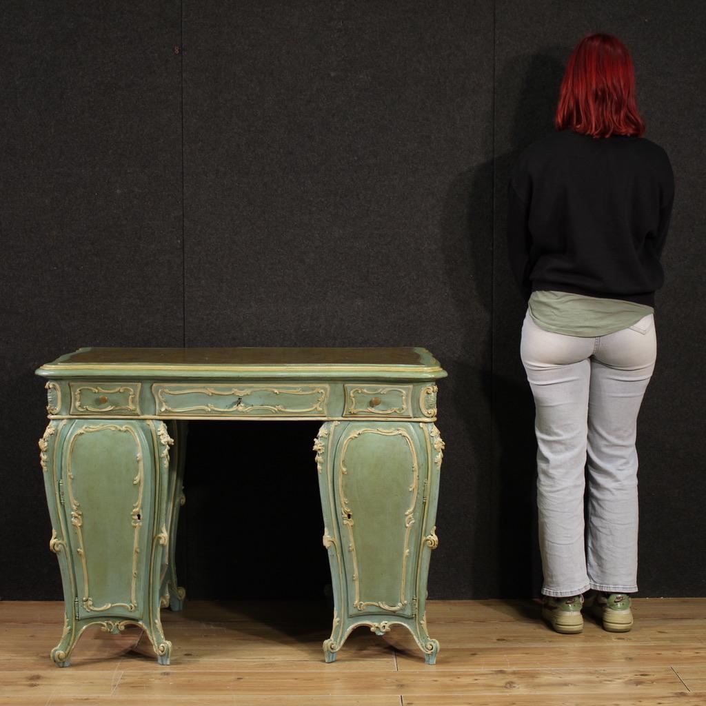 Venetian writing desk from the mid-20th century. Baroque-style furniture, finished for the center, in finely carved, lacquered, and painted wood. Marbled wood top of beautiful size and exquisitely beautiful. The desk features three external parallel