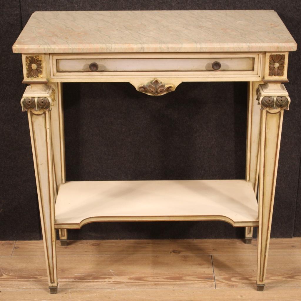 Italian console from 20th century. Furniture in carved, lacquered and gilded wood (bronze tint) in Louis XVI style. Console table equipped with original marble top (glued to the cabinet during the 20th century) of good size and service, a front