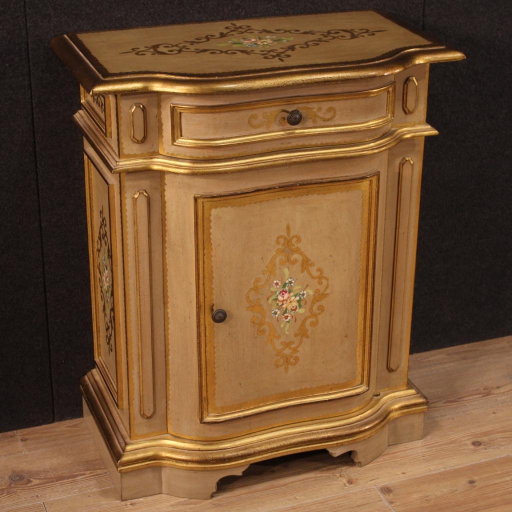 Tuscan sideboard of the  20th century. Furniture in lacquered, gilded and hand painted wood with very pleasant floral decorations. Sideboard with one door and one front drawer of good capacity and service. Interior complete with a flatter support