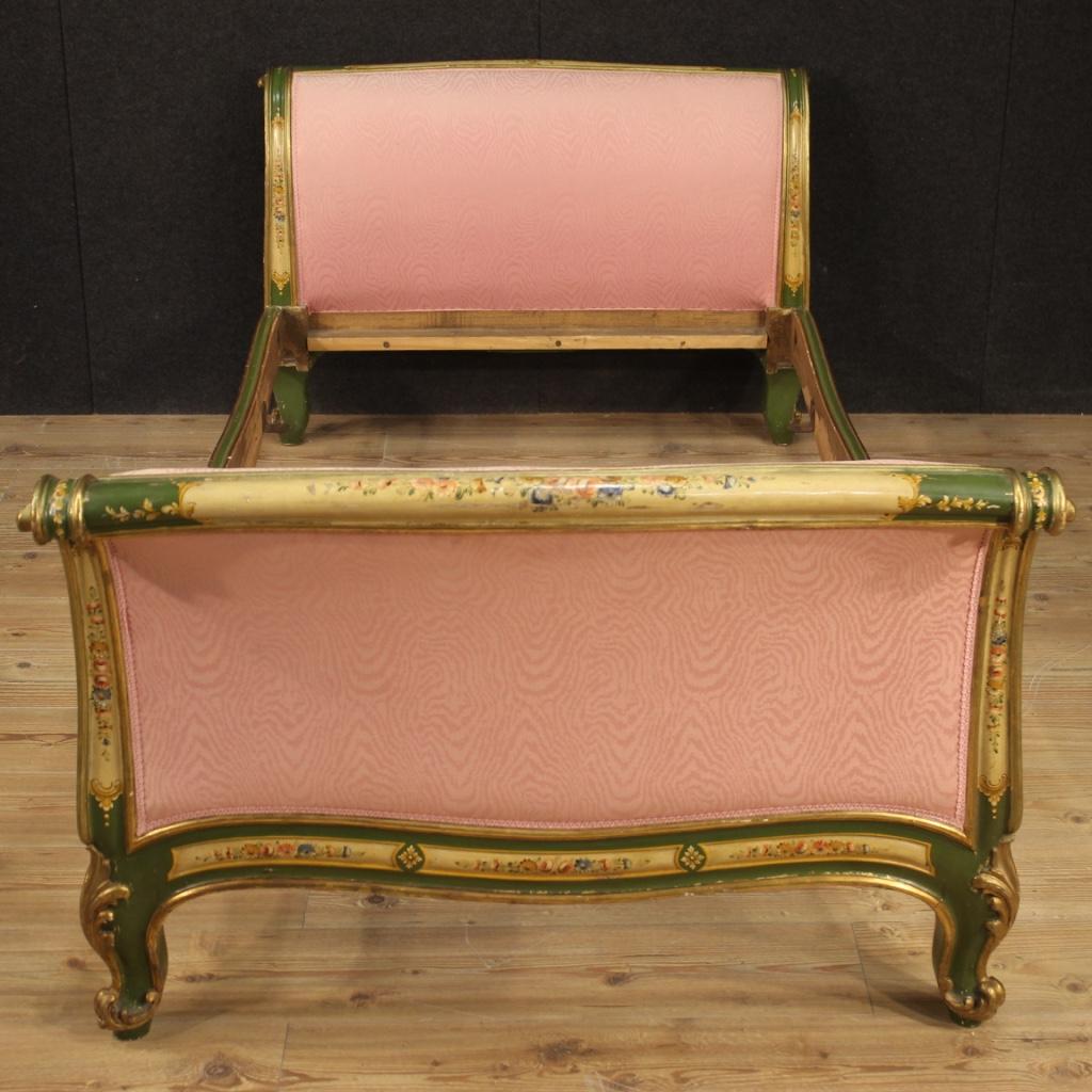 Venetian bed from the mid-20th century. Furniture carved, lacquered and hand painted with floral decorations of great pleasure. Single bed finished for the center covered in fabric with different signs of wear (see photo) to be replaced. Furniture