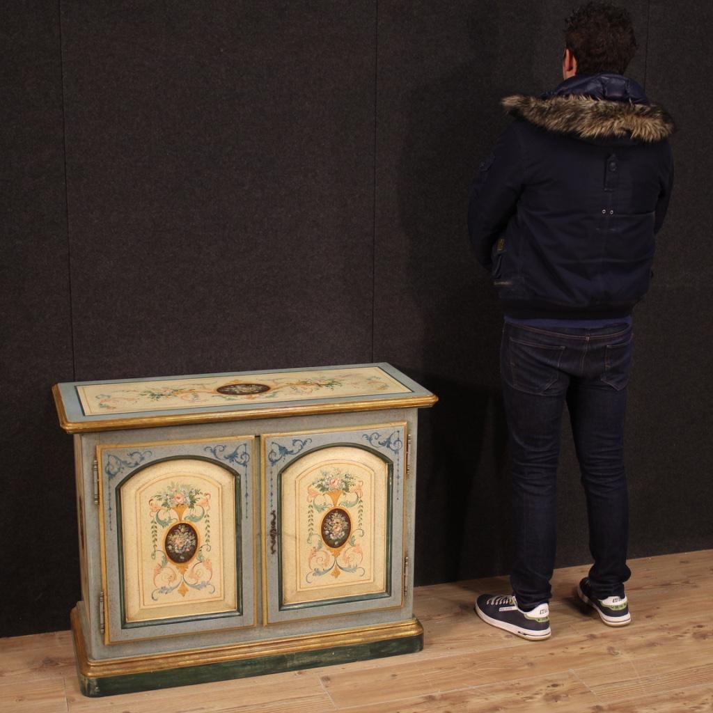 Italian sideboard from the 20th century. Furniture in lacquered, gilded and painted wood with beautiful lines and pleasant decor. Two-door sideboard complete with working key and internal fixed shelf (and a base) of good capacity and service.