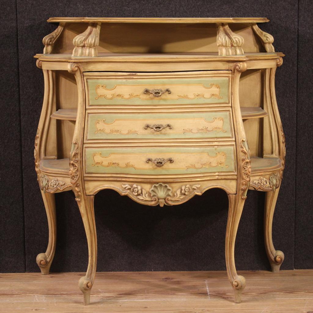 Venetian bedside table from the second half of the 20th century. Furniture in lacquered, gilded and hand painted wood with hand painted floral decorations. Sideboard with fake central chest of drawers that turns out to be a flap door (see photo).
