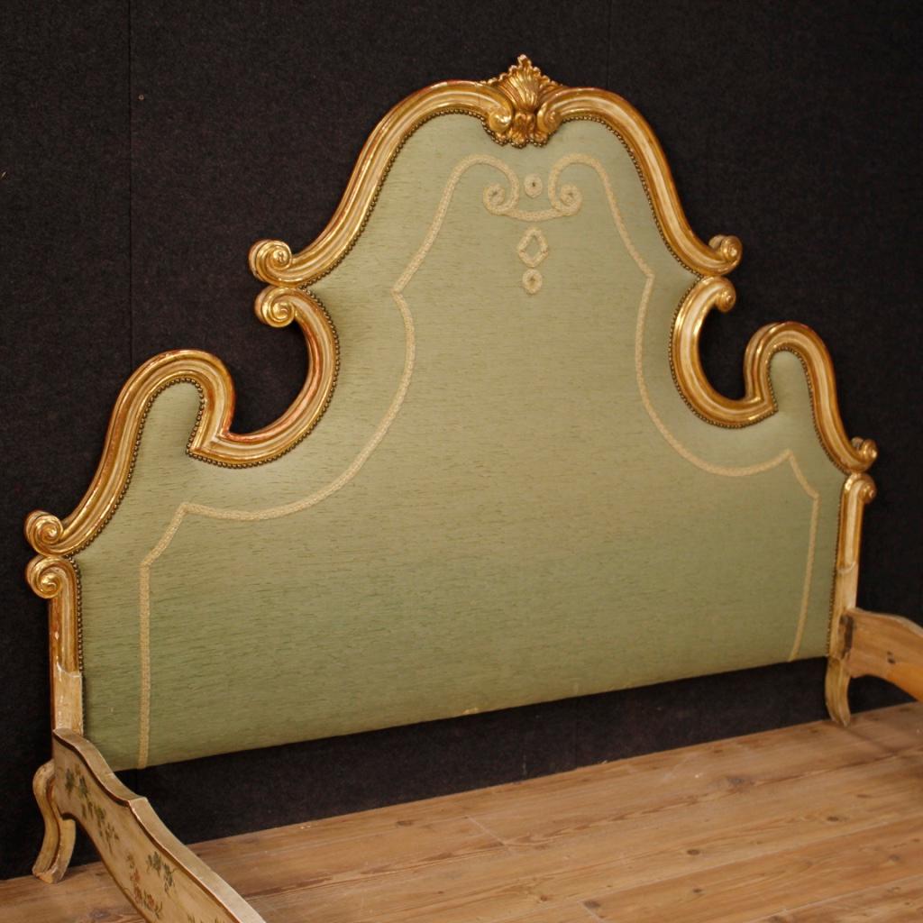 20th century Venetian double bed. Furniture in carved, lacquered, gilded and finely painted wood with very pleasant floral decorations. Bed of fabulous quality and decoration adorned with golden shell on the top of the headboard. Padded headboard