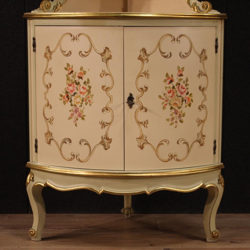 Italian corner cabinet from 20th century. Furniture of beautiful line in lacquered, gilded and hand-painted wood with very pleasant floral decorations. Double body corner cabinet with two doors in the lower part, fixed internal (see photo). Open